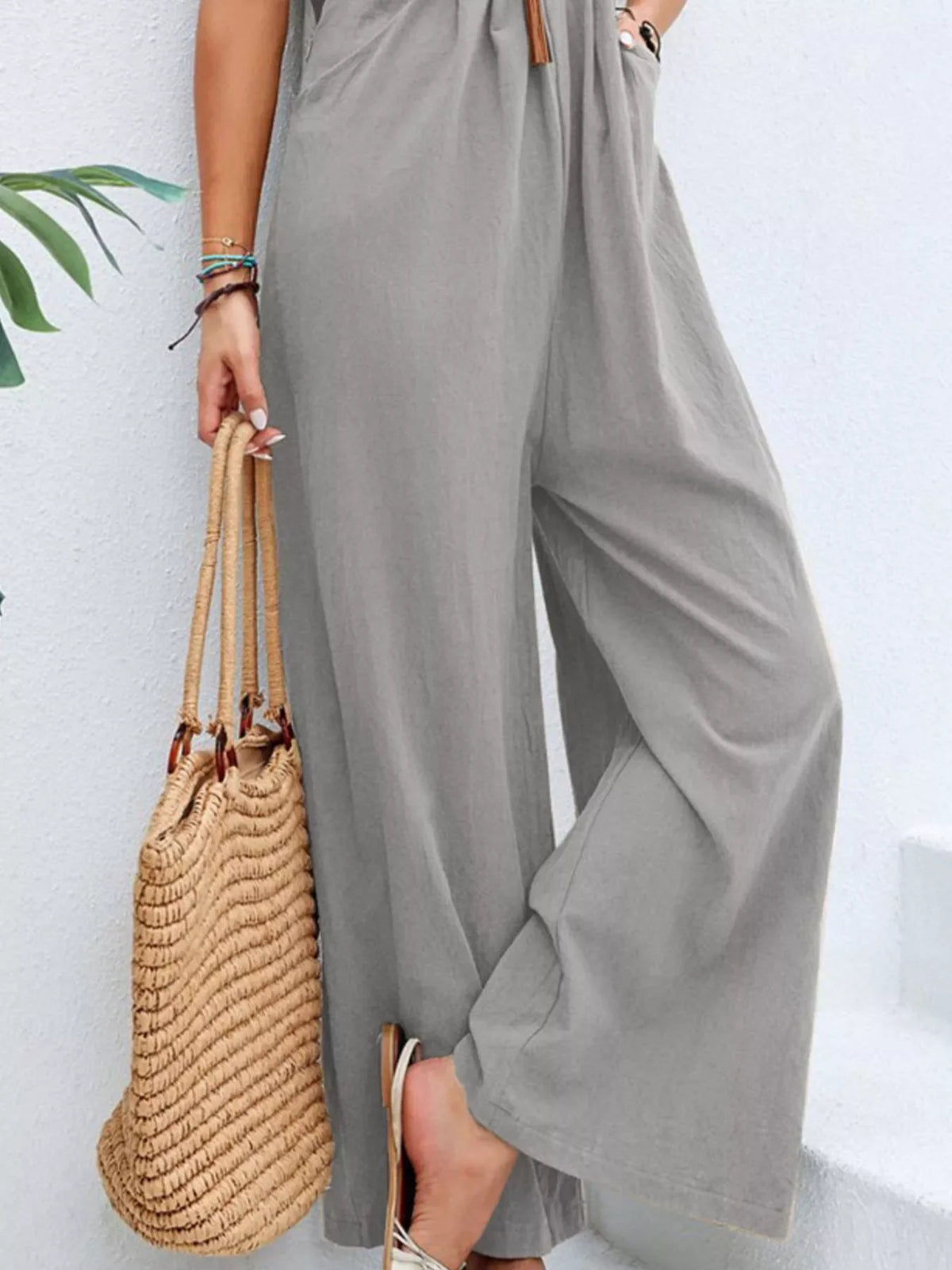 Plus size casual wide-leg jumpsuit with pockets, made by Plush Fashion Hub, featuring a full-length design and comfortable fit.
