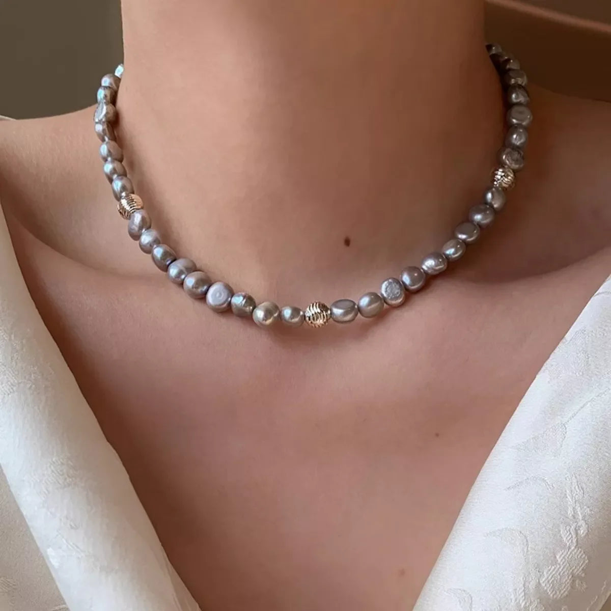 Elegant pearl choker necklace from Plush Fashion Hub featuring a string of lustrous white pearls on a delicate design.