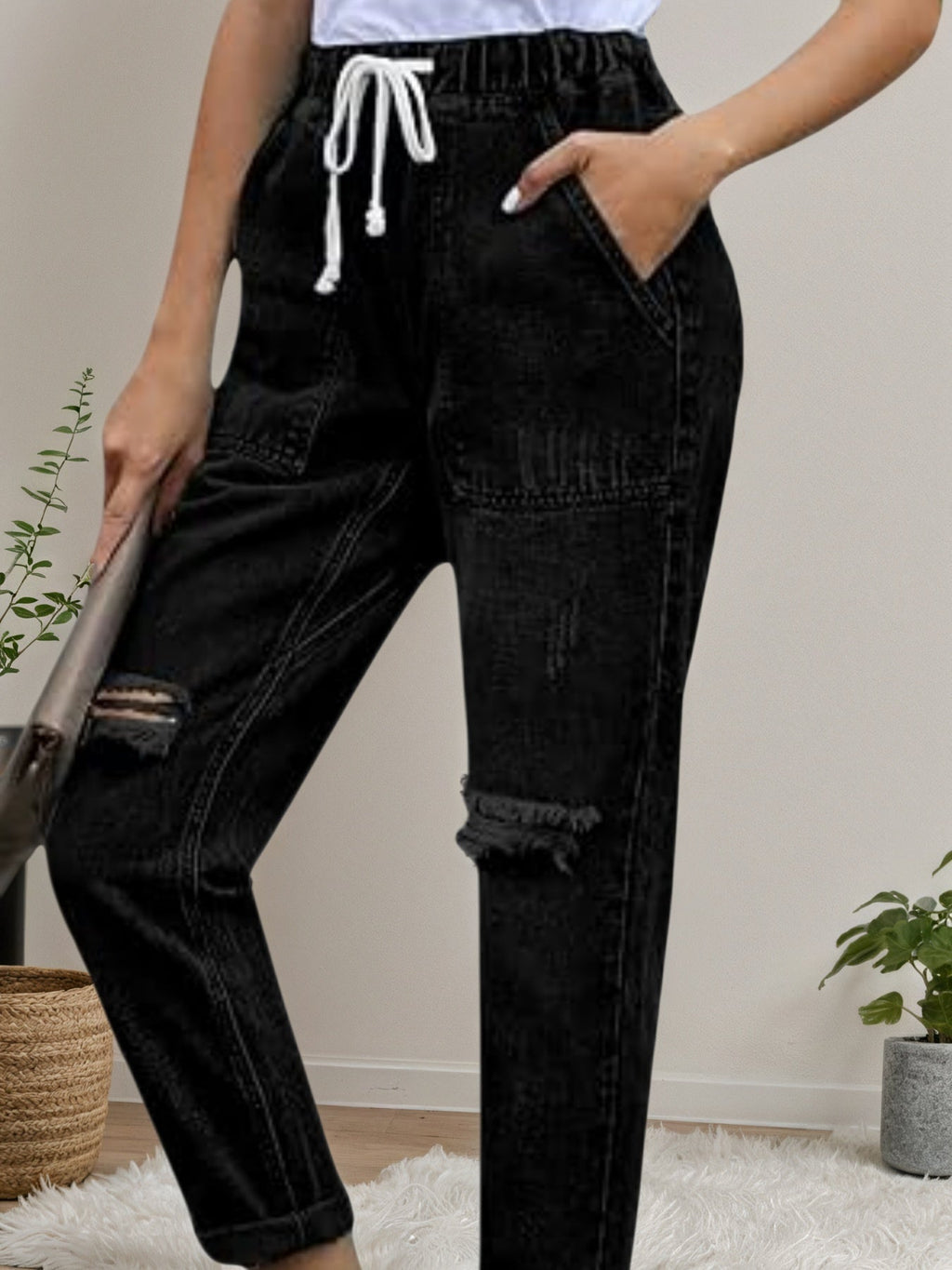 Women’s distressed stretch denim joggers with casual elastic waist from Plush Fashion Hub, featuring a relaxed fit and distressed details.