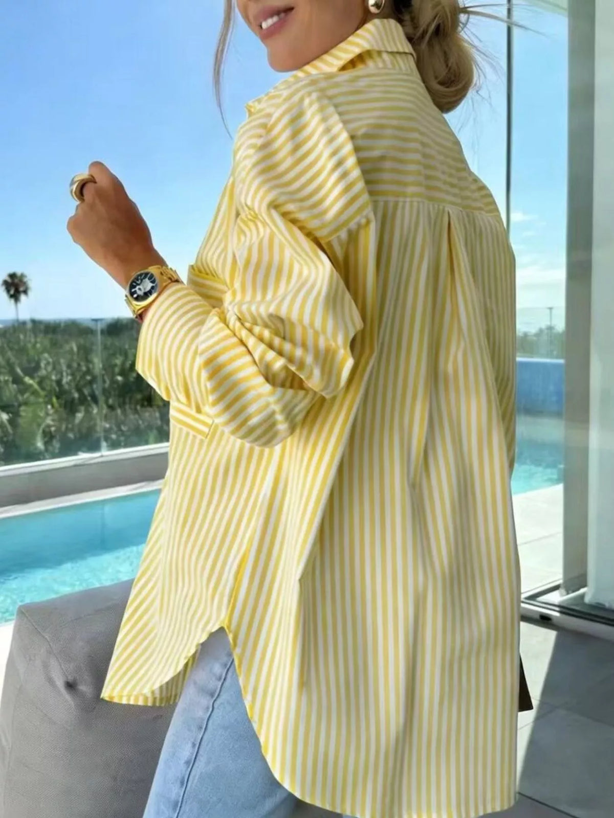 Women's long sleeve button-up striped shirt by Trendsi, featuring a classic design with vertical stripes and a collar.