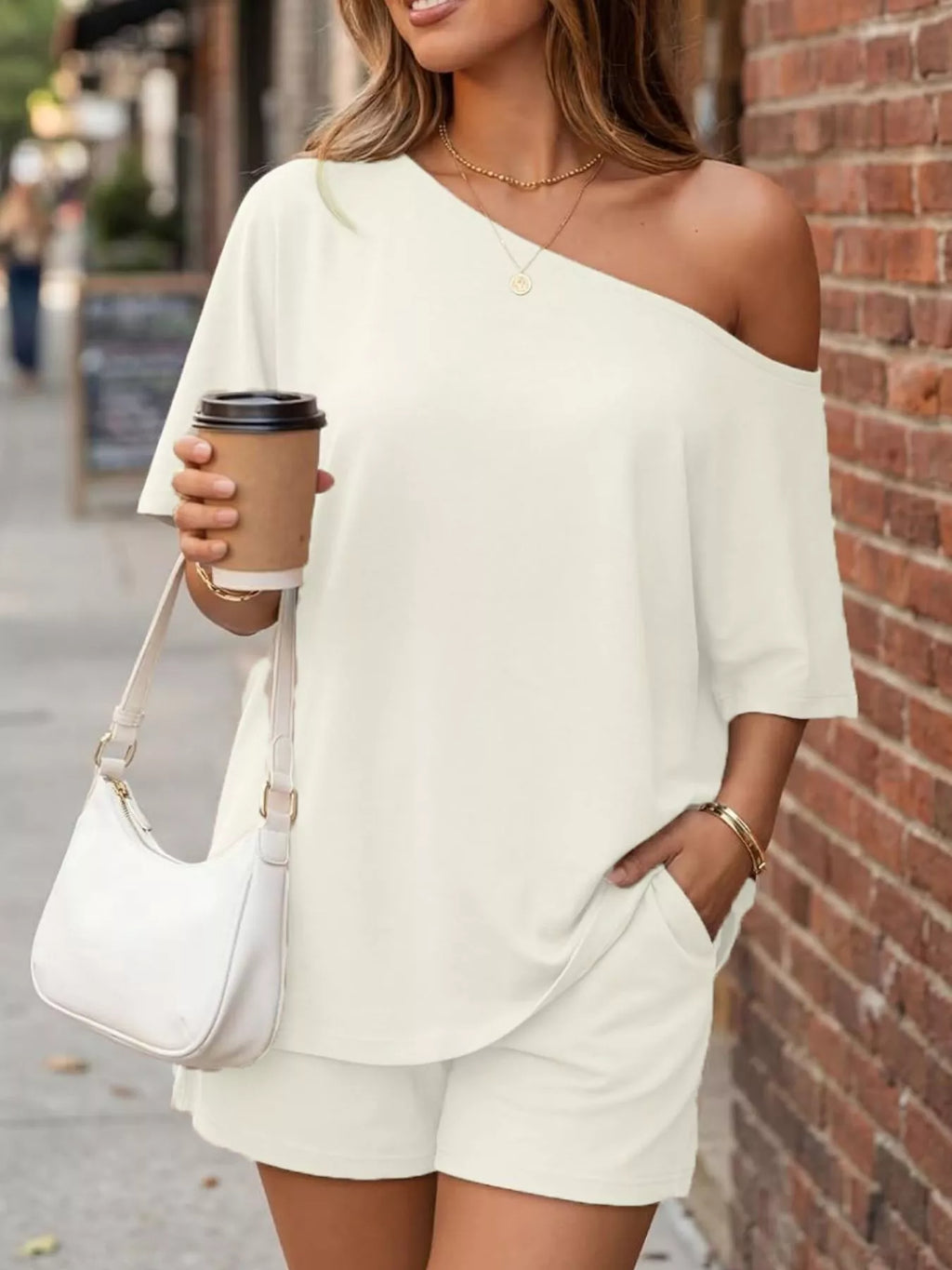 Plus size one shoulder top and matching shorts set from Trendsi, featuring a stylish one-shoulder design and comfortable fit.