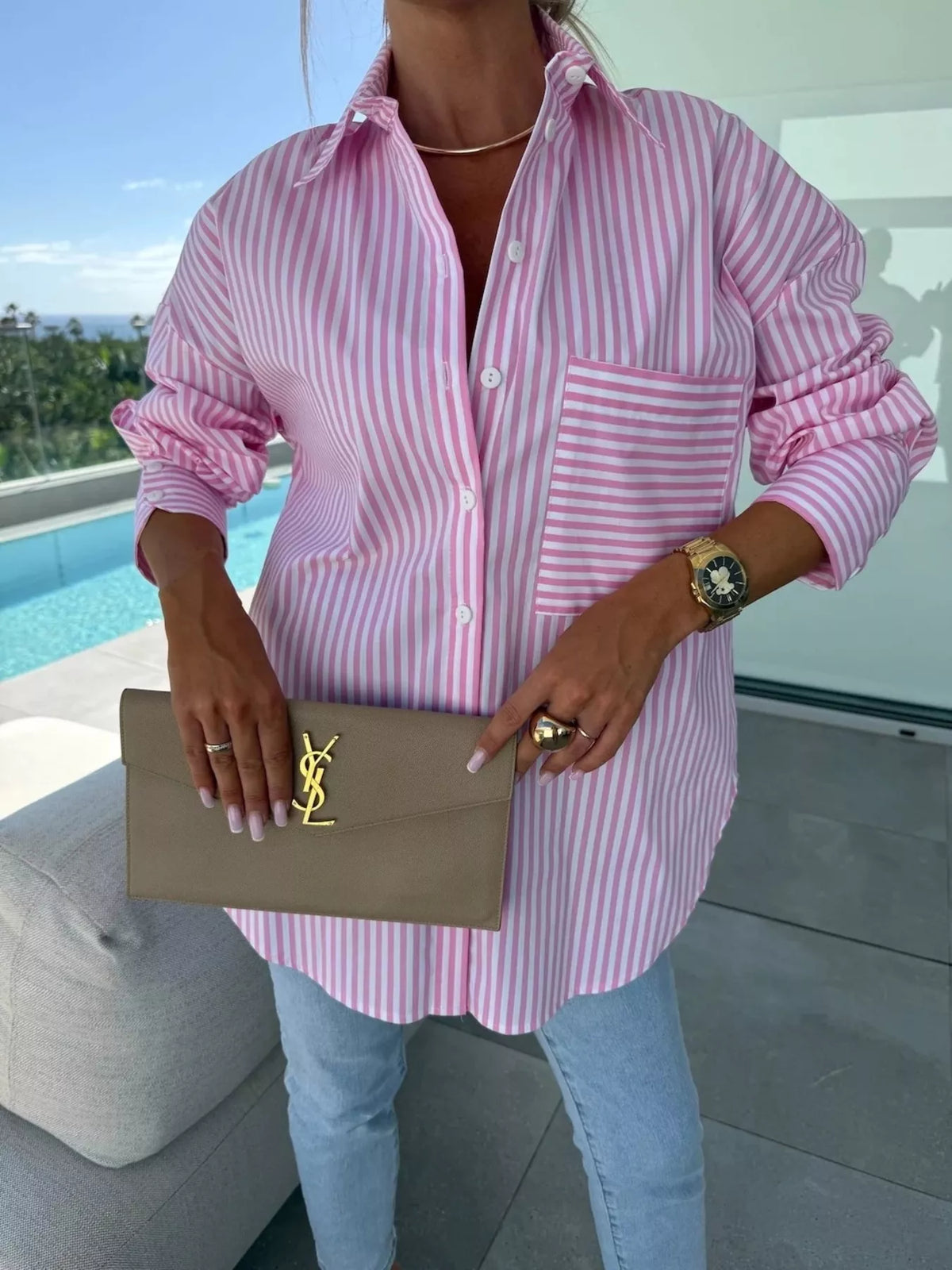 Women's long sleeve striped button-up shirt by Trendsi, featuring a classic design with vertical stripes and a collar.