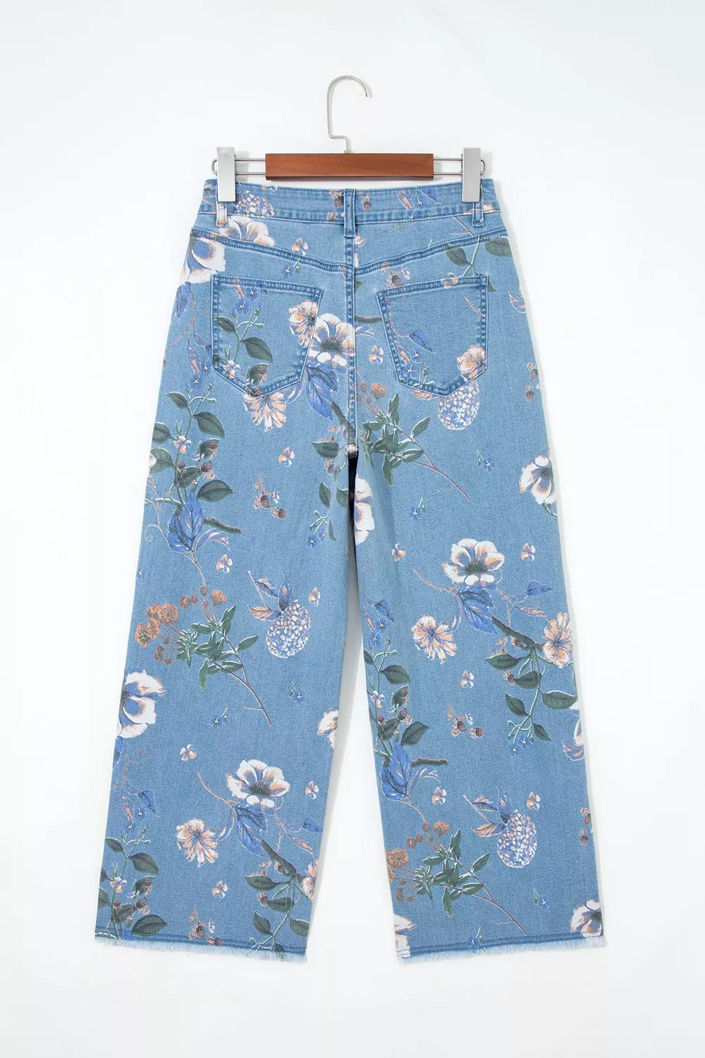 Floral print wide-leg jeans from Trendsi featuring a relaxed fit and vibrant floral pattern on denim fabric.