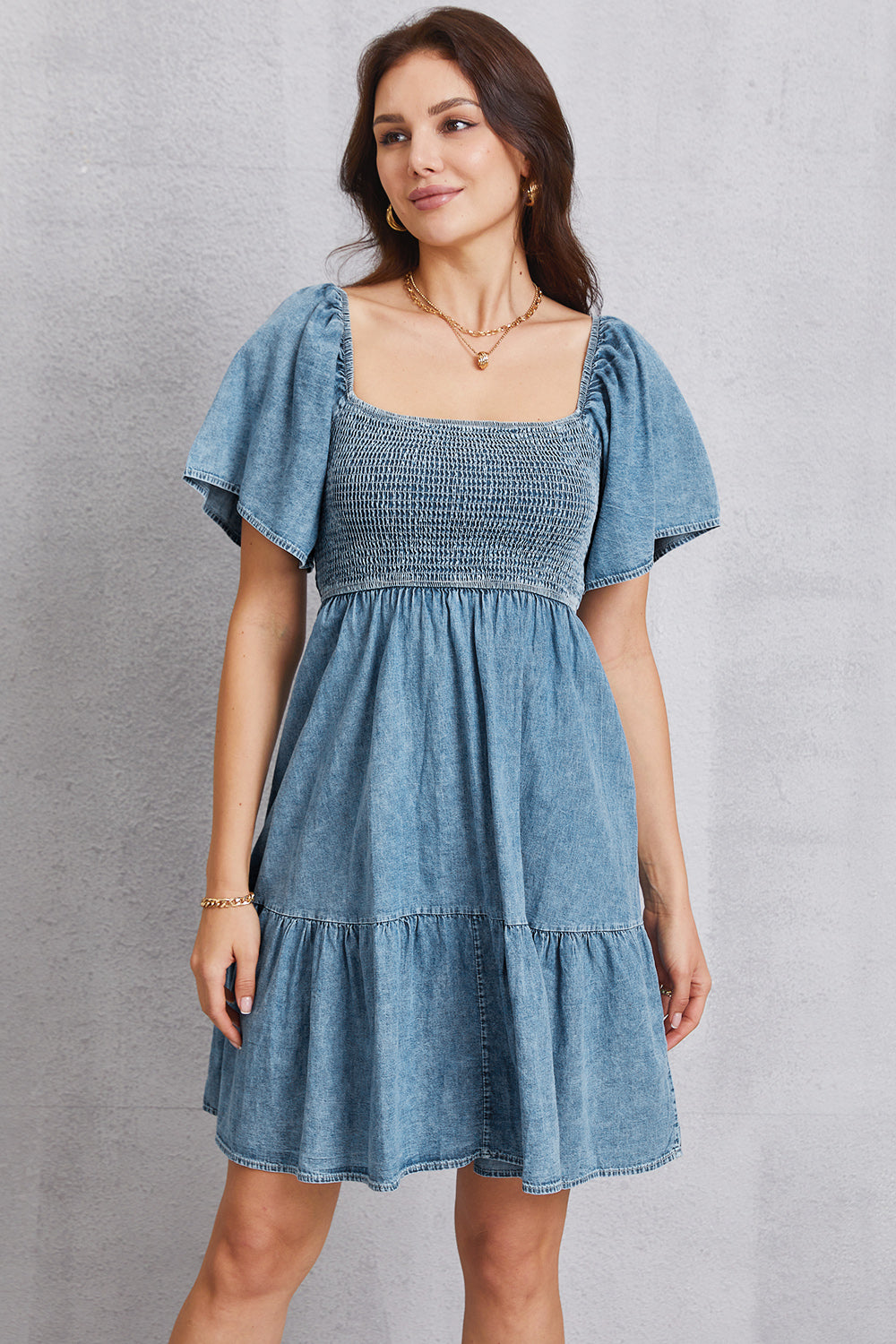 Smocked square neck mini denim dress by Plush Fashion Hub, featuring a fitted bodice and stylish sleeveless design.
