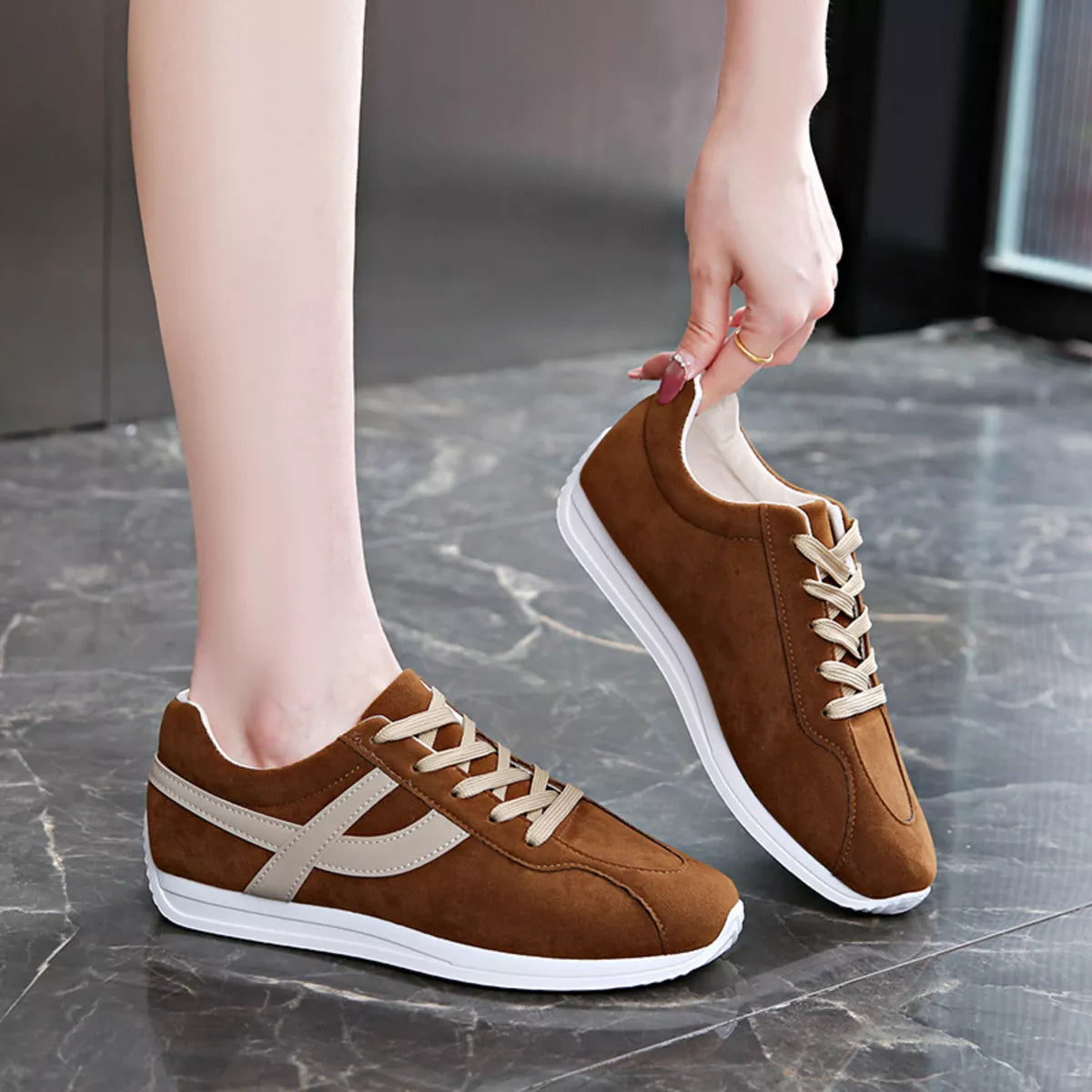 Women round toe lace-up sneakers by Trendsi, featuring stylish design and comfortable fit, shown in a close-up image.