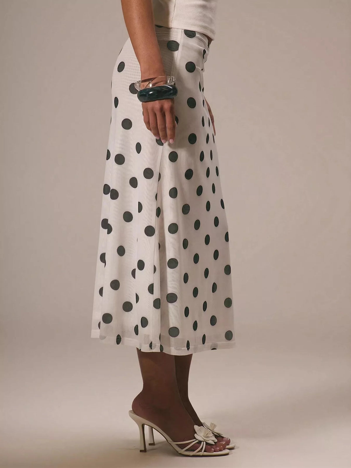 Women's vintage-inspired polka dot midi skirt by Plush Fashion Hub, high-waisted A-line design, perfect for stylish everyday wear.