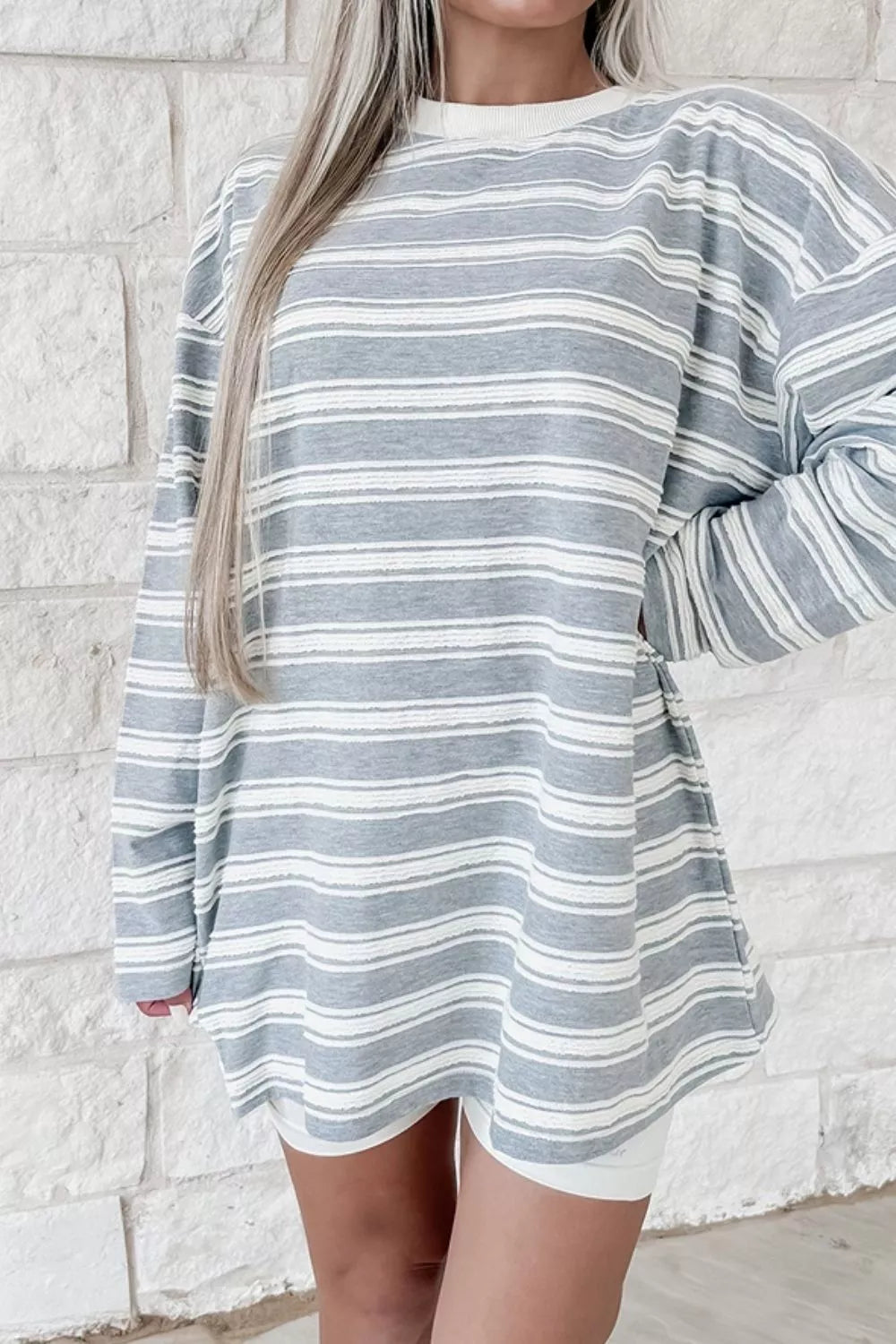 Women's striped oversized long sleeve T-shirt by Trendsi, featuring a casual fit and stylish horizontal stripe pattern.