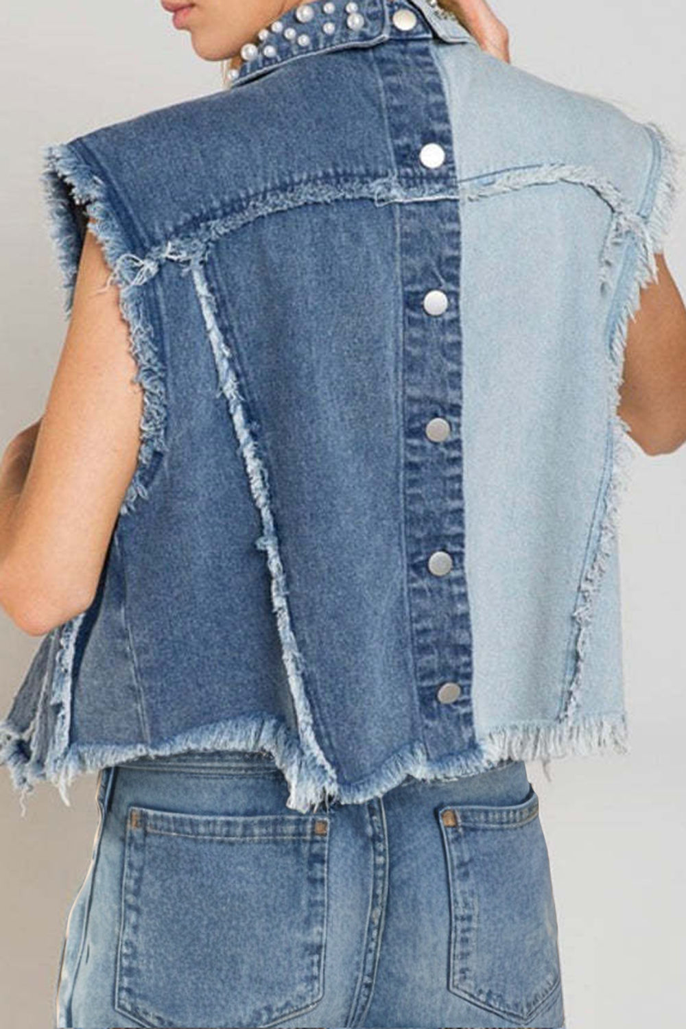 Raw hem sleeveless denim jacket with pearl accents, stylish clothing from Plush Fashion Hub, shown on a model.