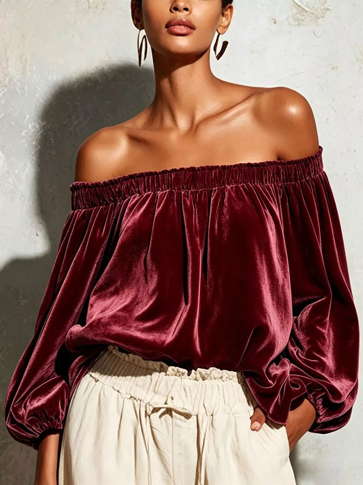 Off-shoulder velvet long sleeve T-shirt by Trendsi, featuring a stylish fit and soft fabric, shown on a model.