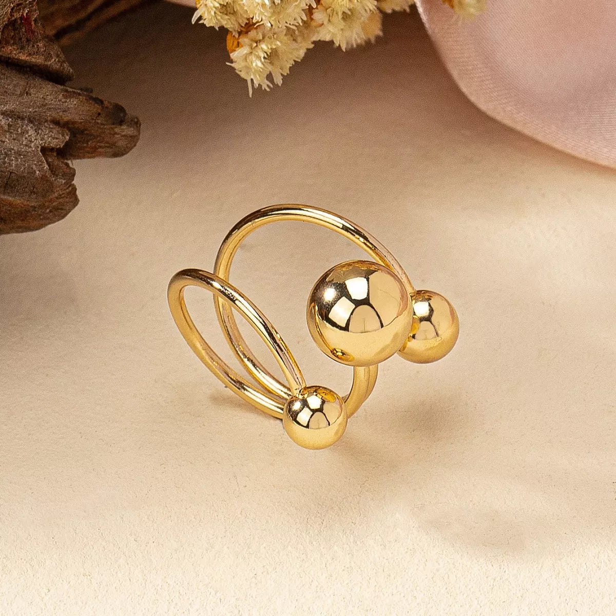 Multi-layered ball ring by Plush Fashion Hub featuring stacked silver rings with spherical accents, stylish and modern jewelry piece.