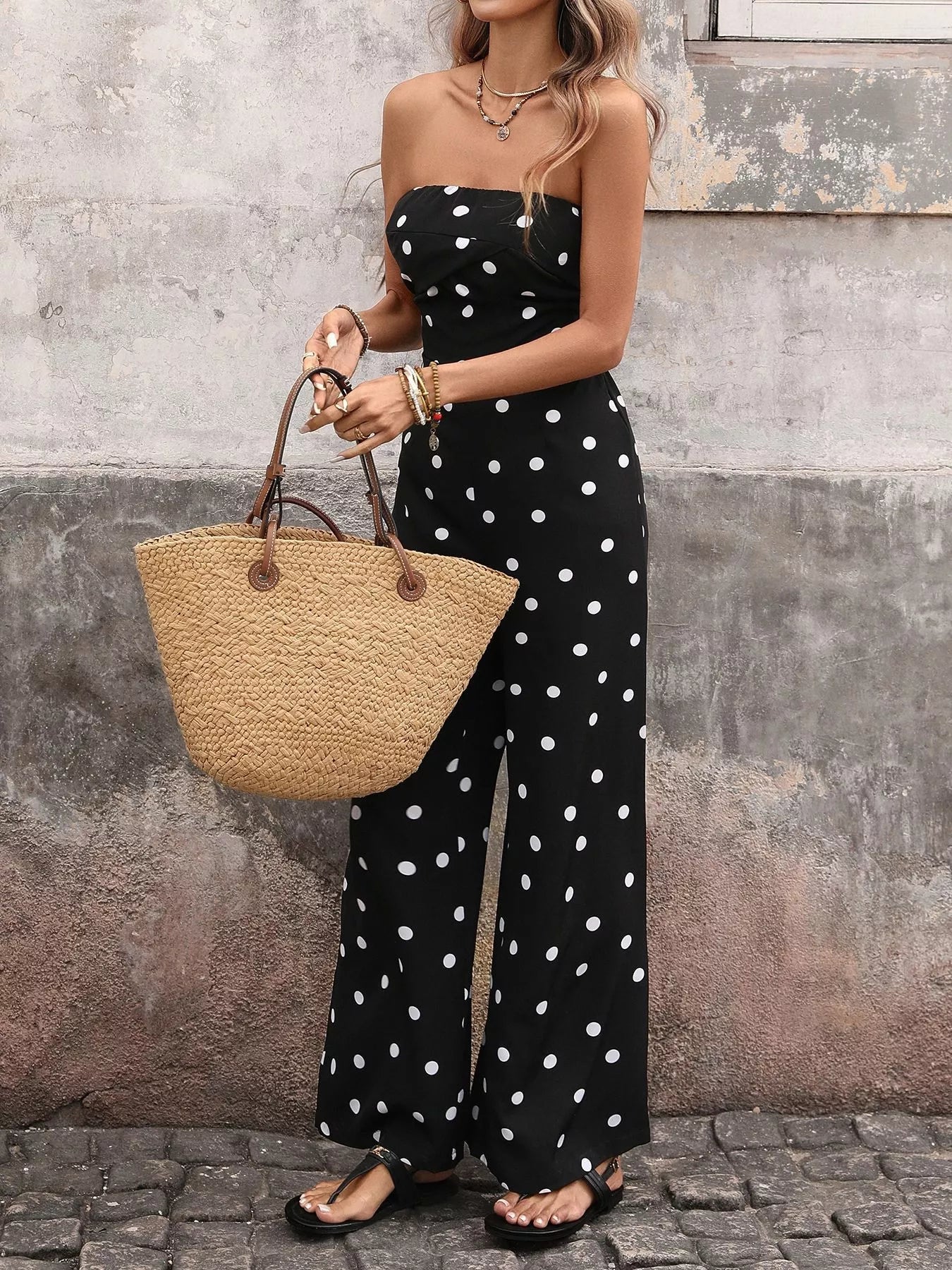 Polka dot strapless wide-leg jumpsuit by Trendsi, featuring a flowy, comfortable design perfect for casual or semi-formal wear.