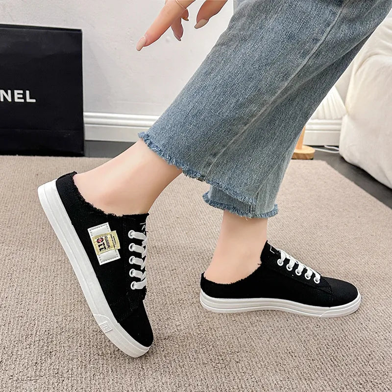 Frayed hem lace-up canvas sneakers with distressed detailing, casual footwear by Trendsi featuring a trendy, relaxed style.