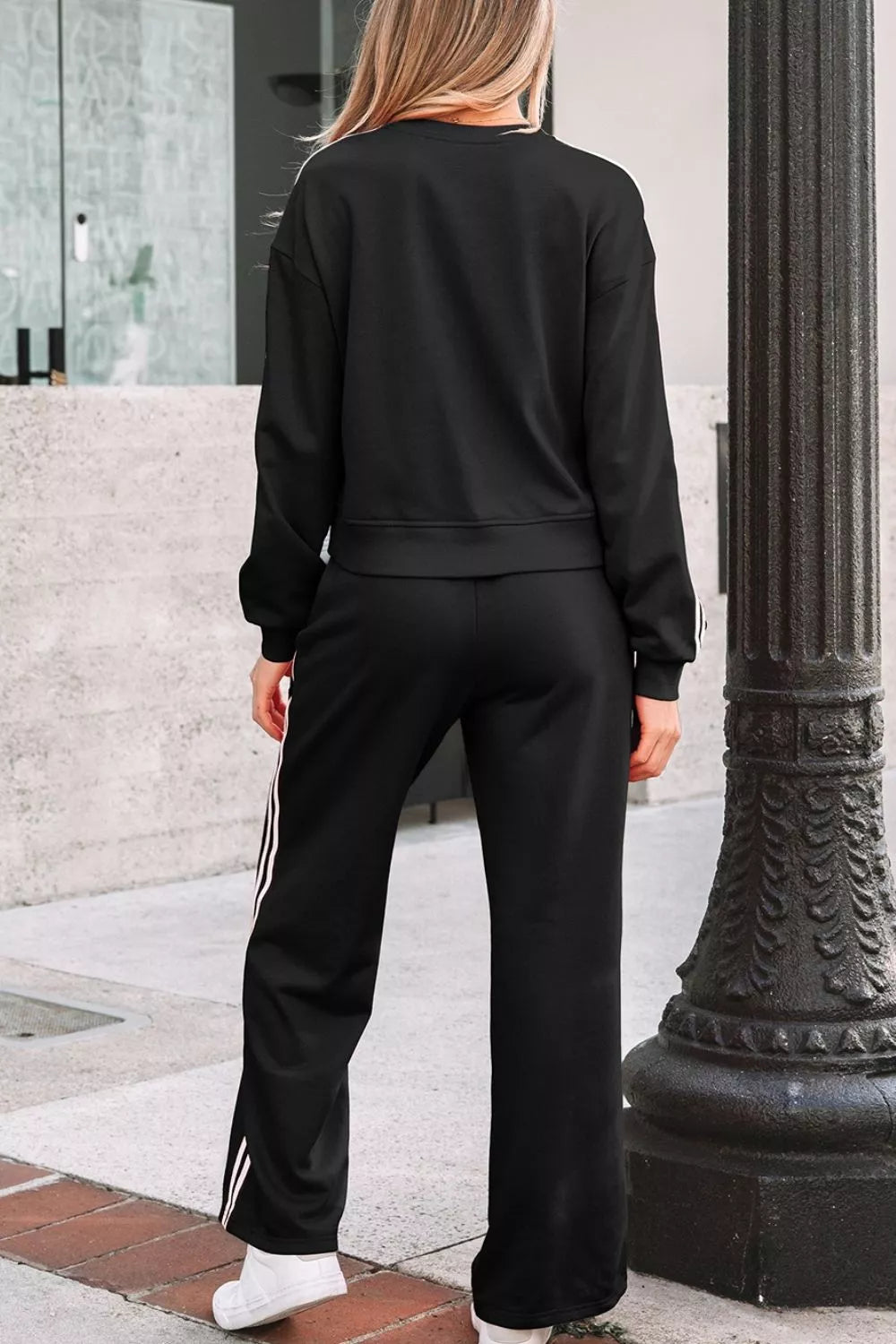 Striped detail crewneck pullover and elastic sweatpants set by Trendsi, featuring matching striped pattern and comfortable fit.