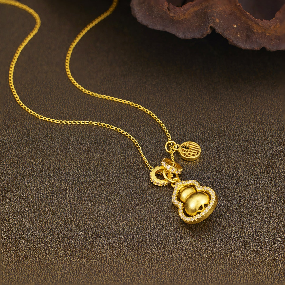 Gold-plated gourd pendant necklace from Plush Fashion Hub featuring a sleek, elegant design on a delicate chain.