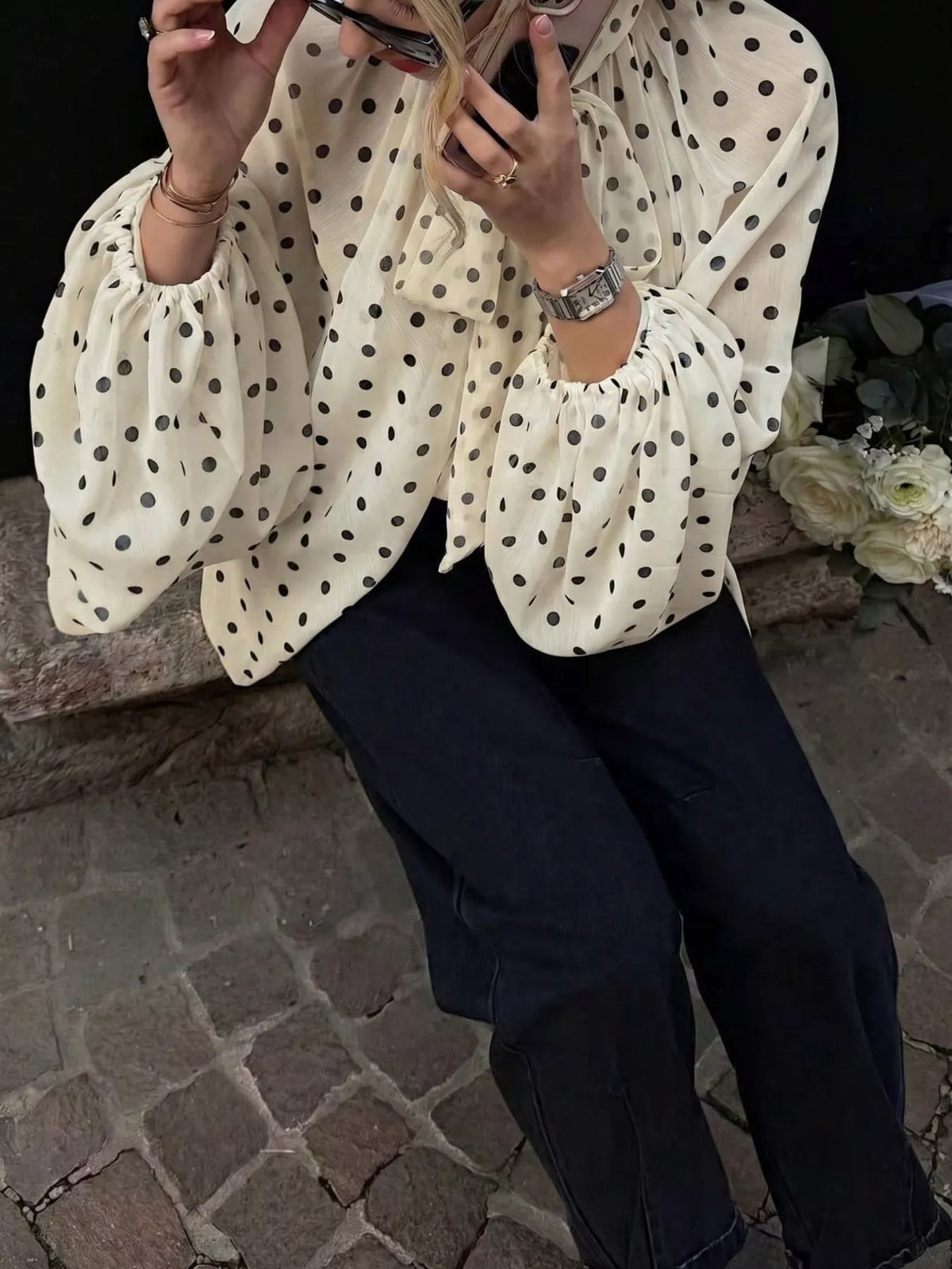 Polka dot balloon sleeve blouse for women by Trendsi, featuring a stylish design with puffed sleeves and a classic polka dot pattern.