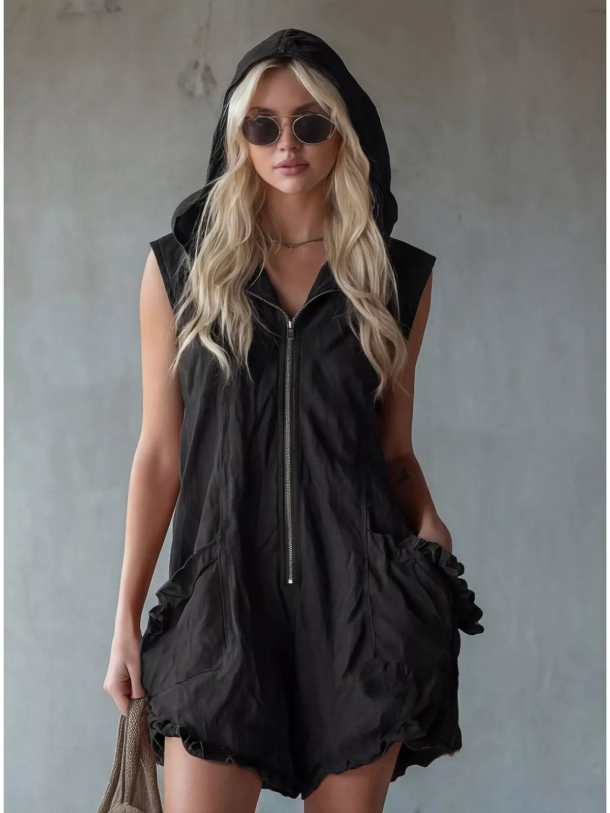 Plus size hooded sleeveless zipper romper with ruffled pockets, featuring a full-length design and casual style by Plush Fashion Hub.