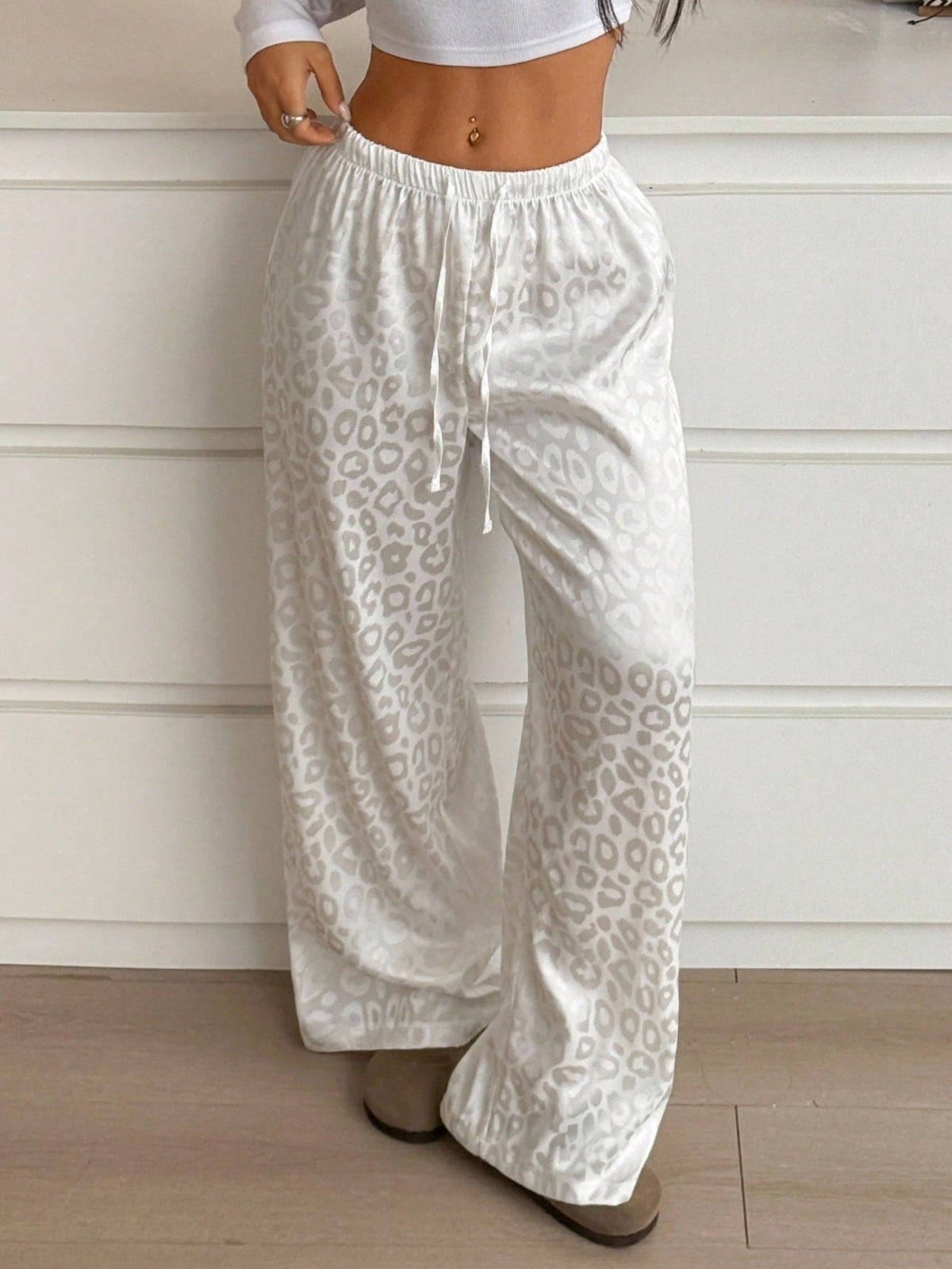 Women’s leopard print wide leg trousers from Plush Fashion Hub with adjustable drawstring waist and relaxed fit.