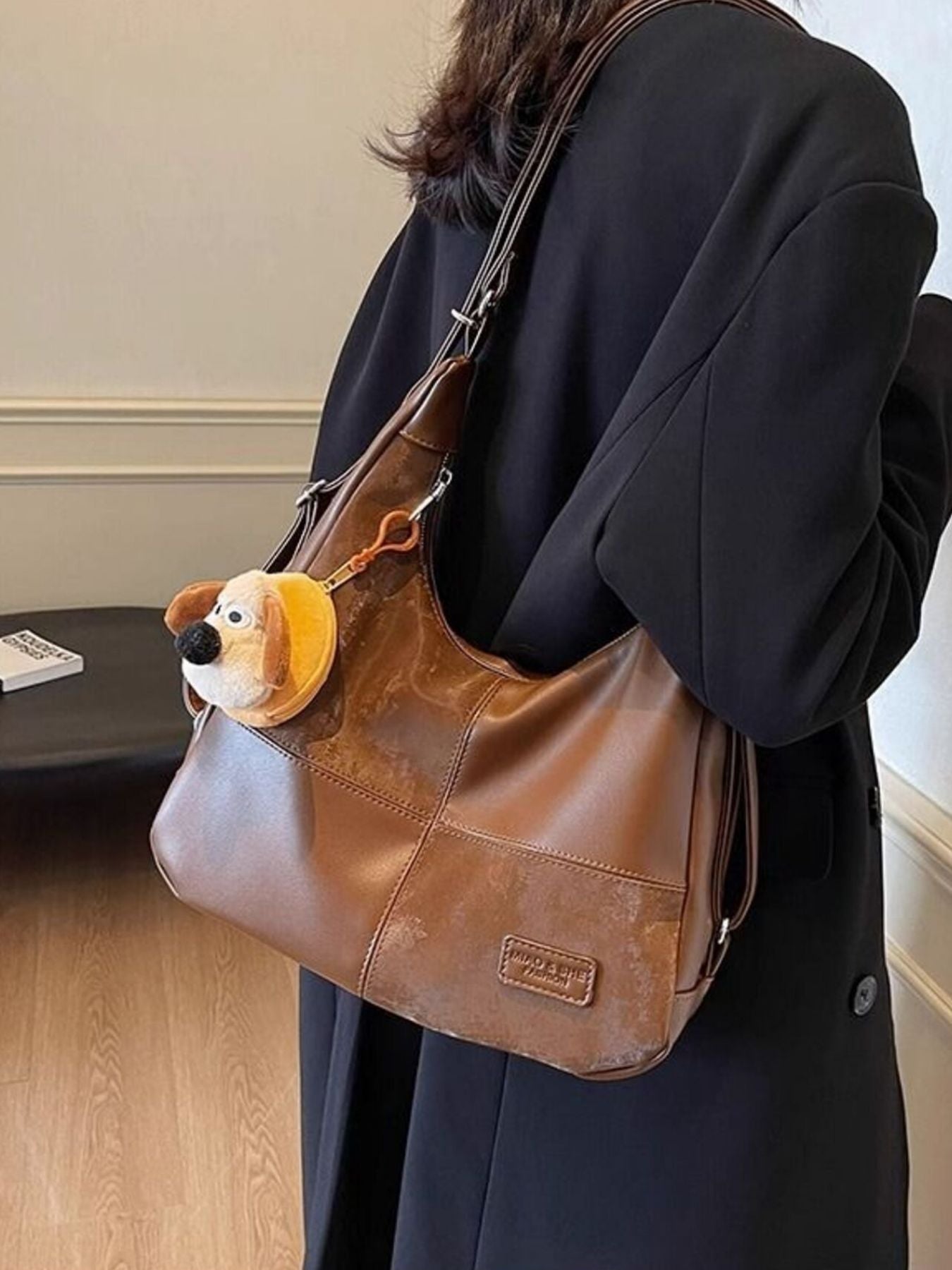 Vintage-inspired PU leather slouchy hobo shoulder bag with a relaxed design and spacious interior, perfect for casual style.