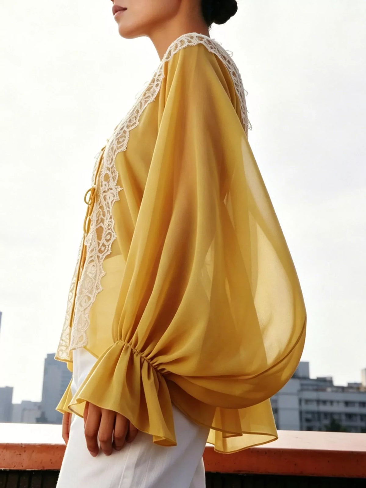 Sheer lace-trimmed front tie blouse for women, stylish lightweight blouse with delicate lace details and long sleeves.