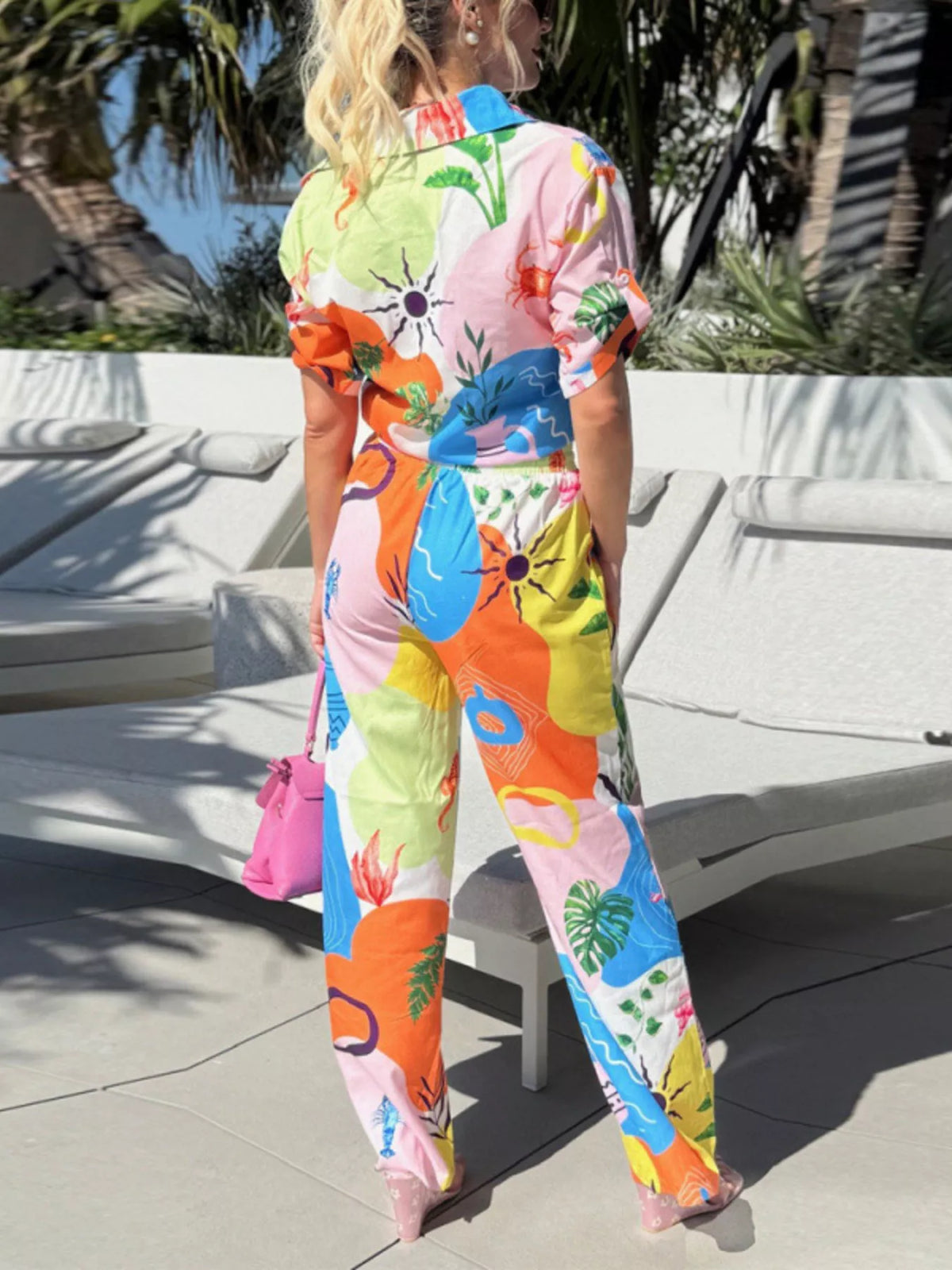 Abstract print button-up shirt and wide-leg pants set by Trendsi, featuring stylish, coordinated clothing with bold patterns.