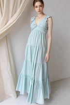 Women's cotton ruffled V-neck tiered midi dress by Trendsi, featuring a flowy design with ruffle details and a V-neck neckline.