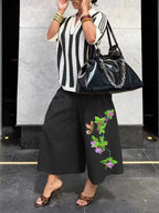 Women's wide-leg cargo pants by Plush Fashion Hub featuring zipper and button details, styled for casual and streetwear looks.