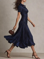 Striped pleated short sleeve midi dress by Trendsi featuring a flowy silhouette and midi length, perfect for casual or semi-formal occasions.