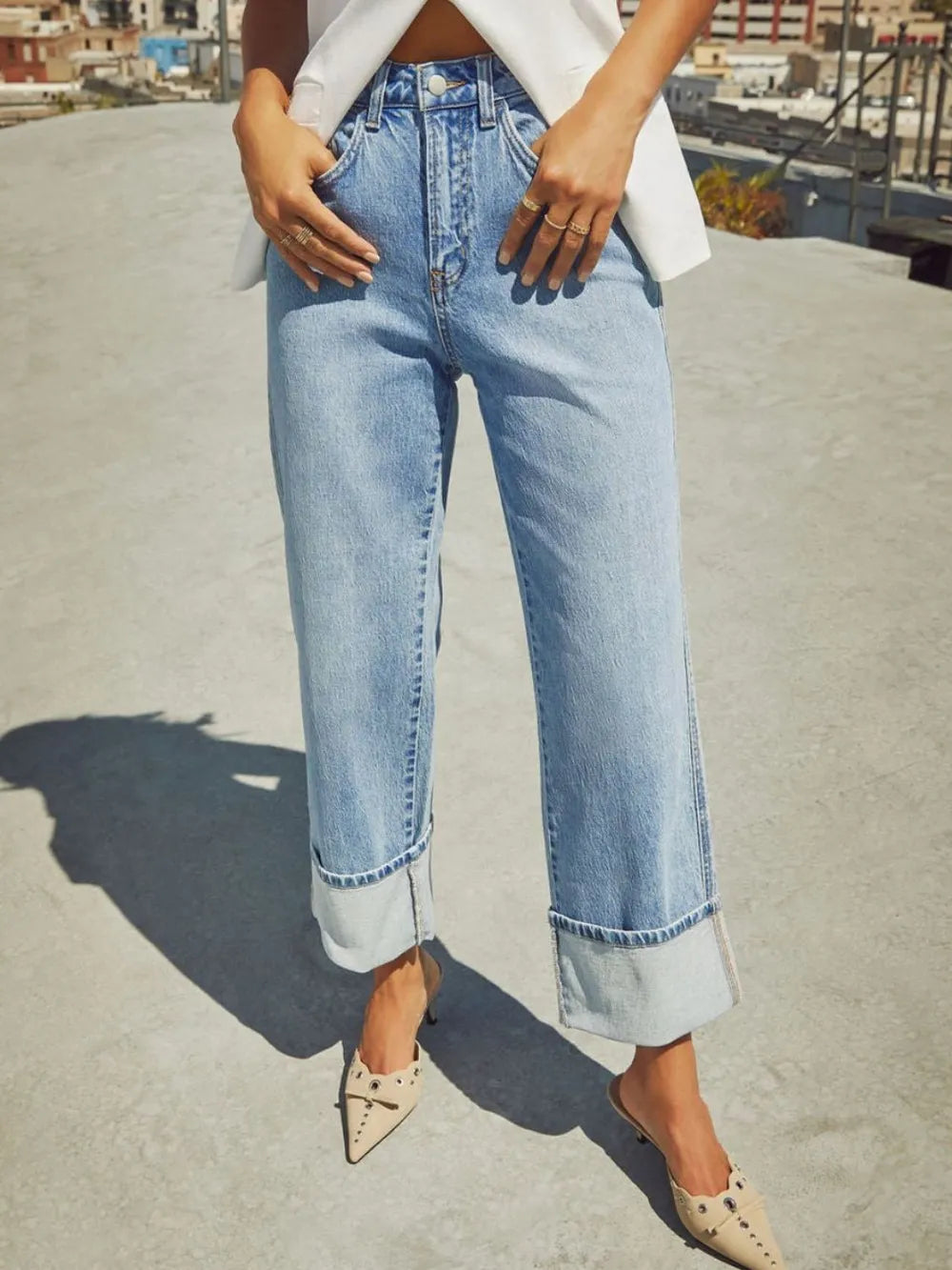 Trendsi high waisted straight leg rolled denim jeans displayed on a hanger, showcasing classic blue denim and rolled cuff details.
