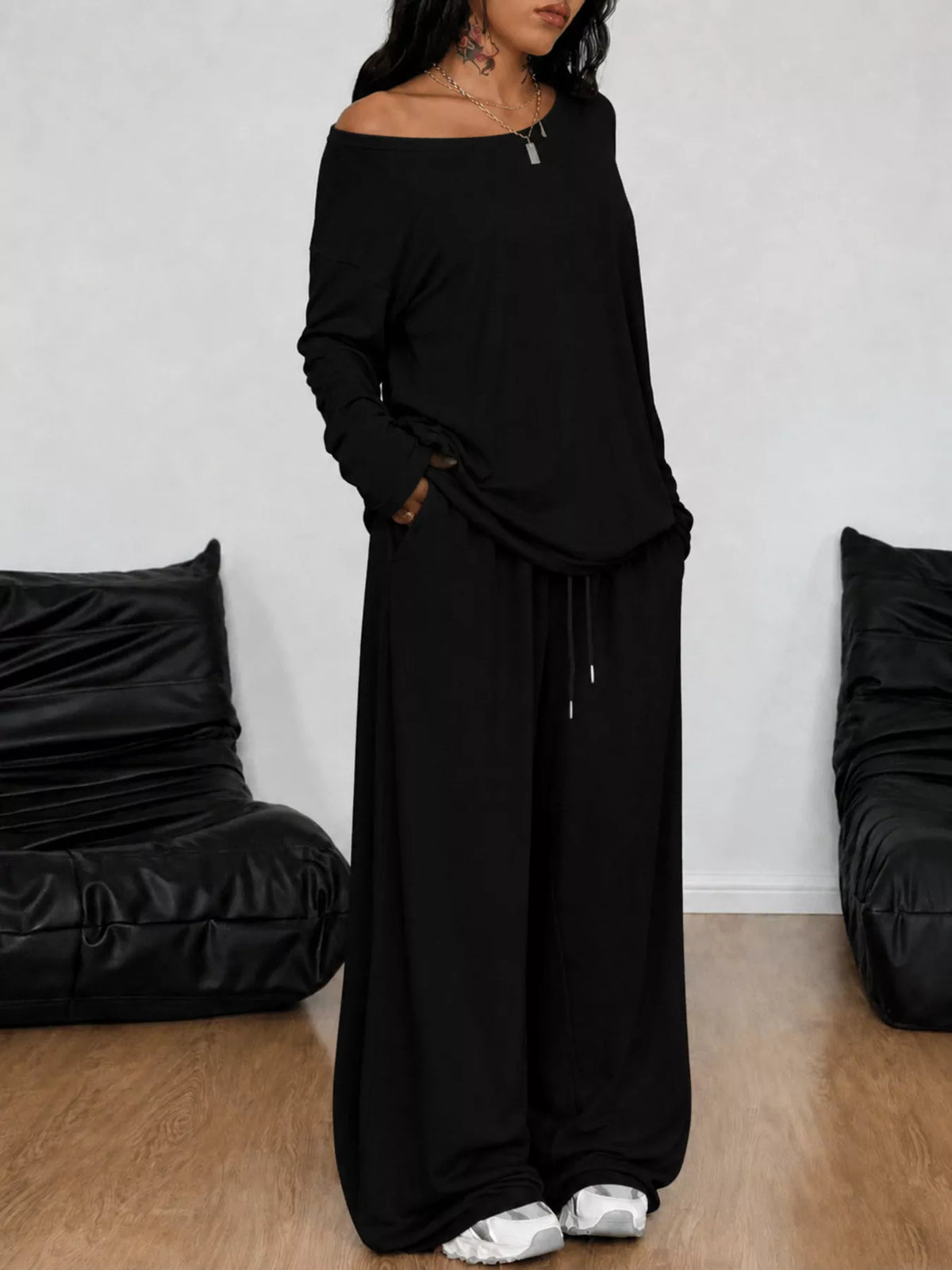 Plus size loose fit one-shoulder T-shirt and pants set by Trendsi, featuring a relaxed style in a matching casual outfit.