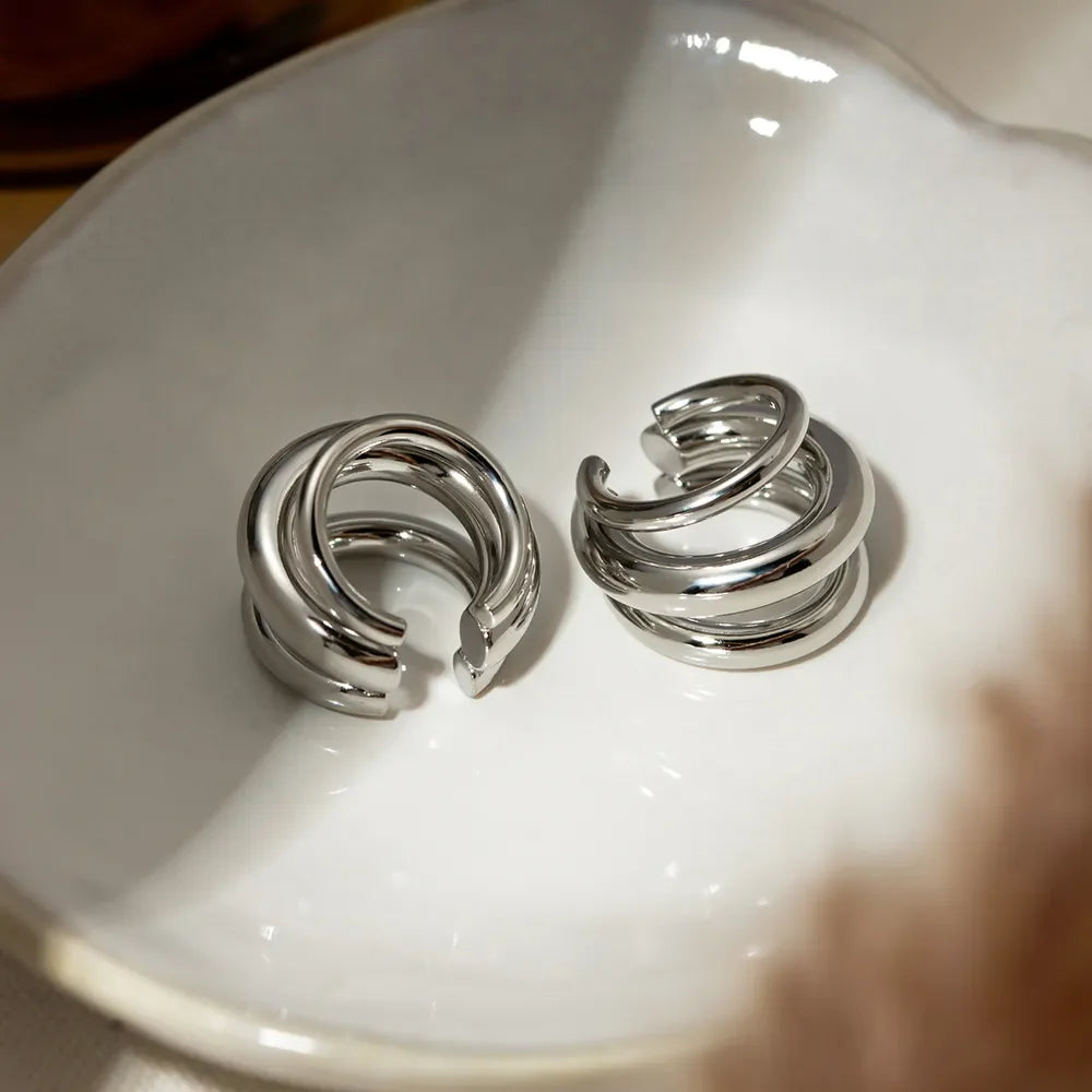 Stainless steel layered cuff earrings with a sleek, modern design, perfect for fashionable accessories and jewelry enthusiasts.