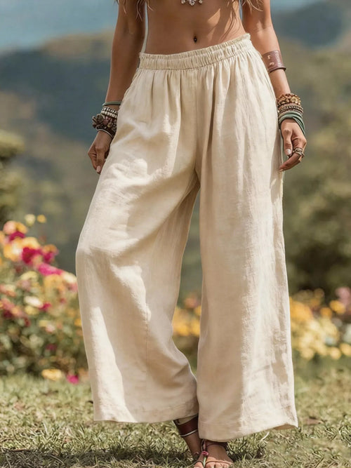 Plus size bohemian wide-leg pants from Trendsi, featuring flowy fabric and relaxed fit, shown in a full-length view.