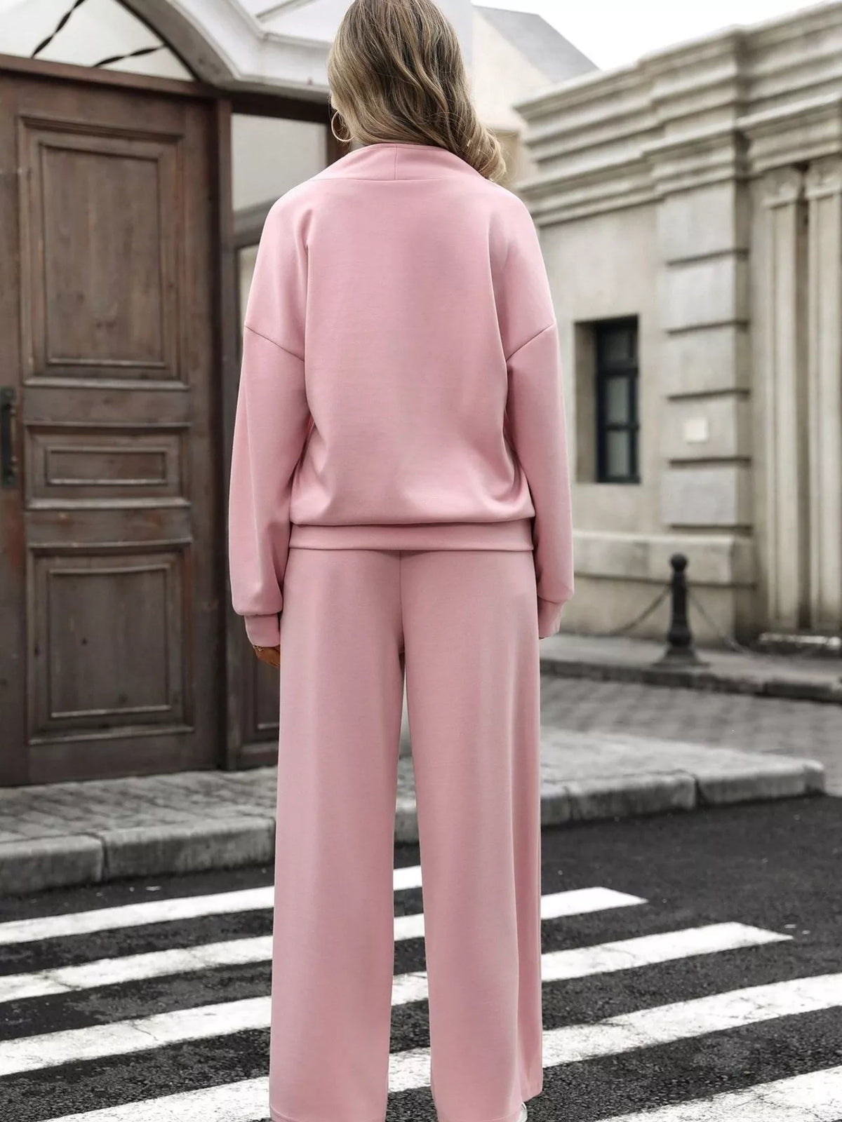 Women’s half zip sweatshirt and wide-leg pants set by Trendsi, featuring a comfortable, casual outfit in neutral tones.