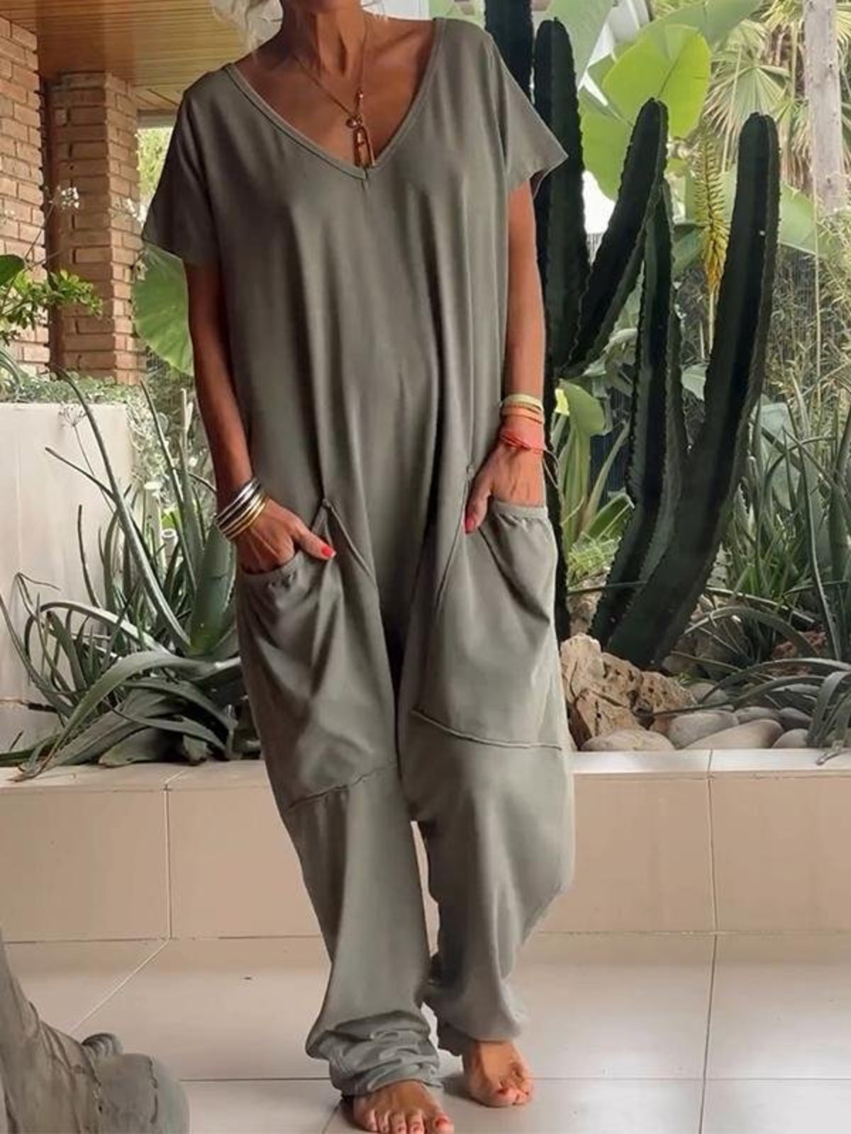 Plus size loose fit V-neck short sleeve jumpsuit with wide legs, trendy and comfortable from Trendsi.