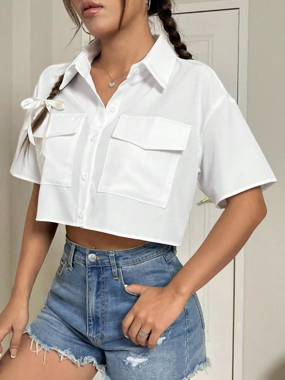 Short sleeve crop shirt with chest pockets from Trendsi, featuring a stylish, casual tops design perfect for warm weather.