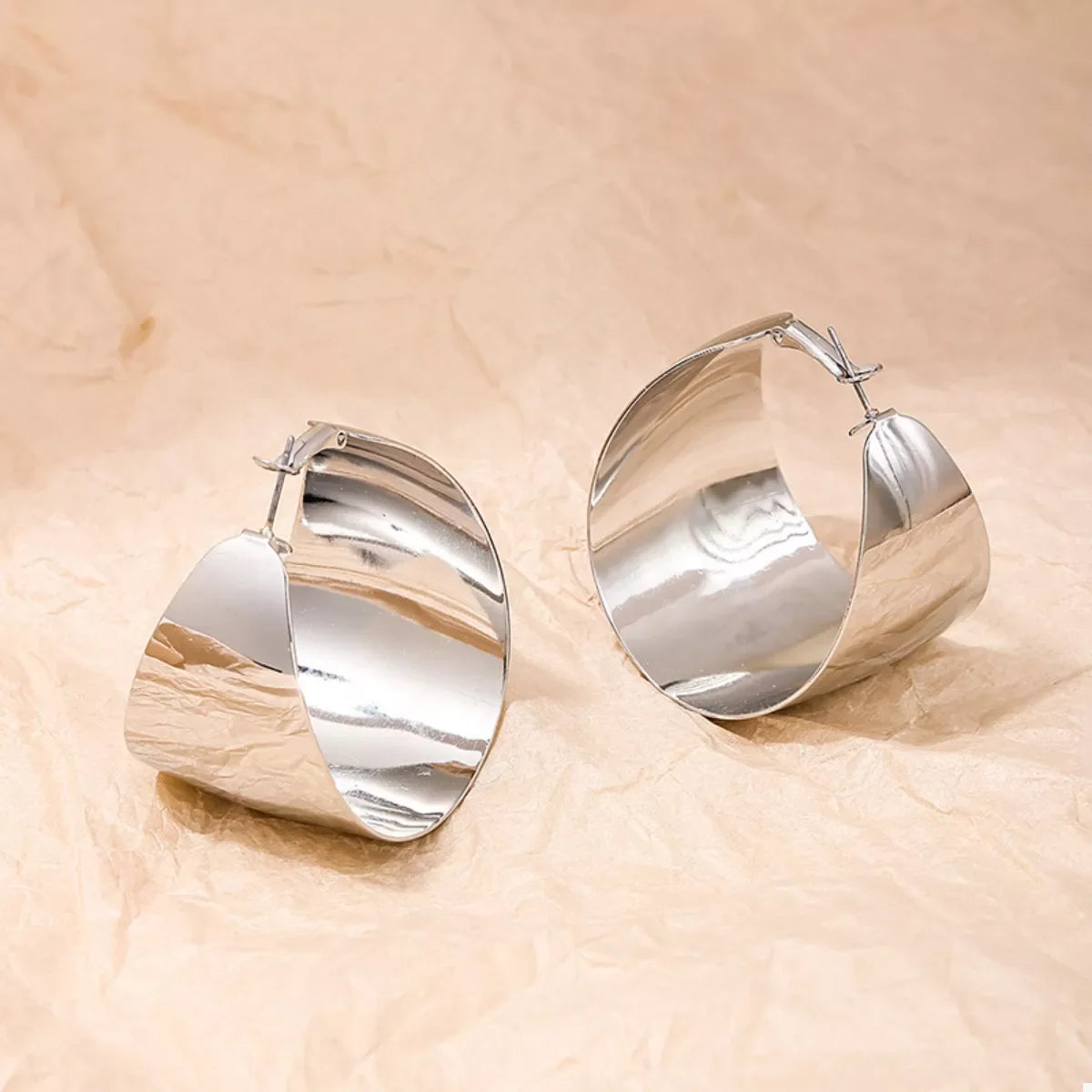 Plush Fashion Hub alloy wide hoop earrings with a polished gold finish, large circular design, and smooth surface.