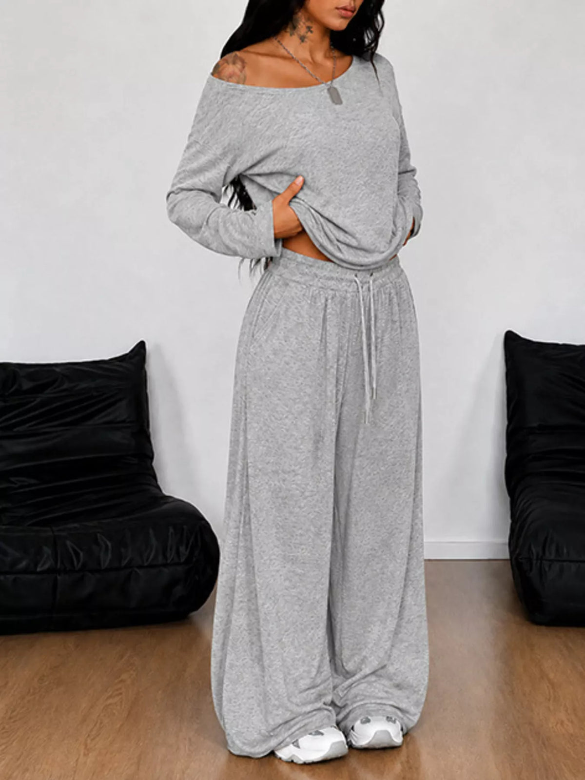 Plus size one-shoulder top and drawstring pants set from Trendsi, featuring a stylish matching outfit with a modern design.