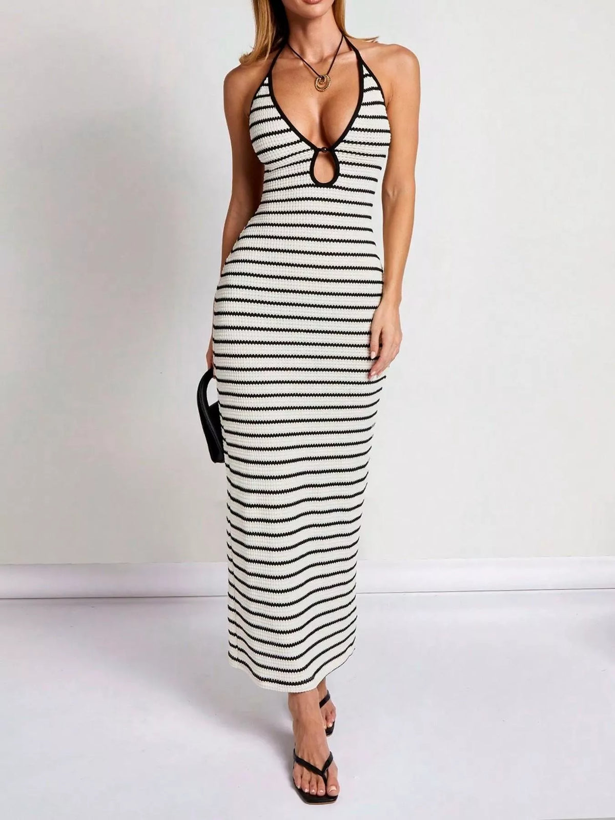 Striped halter neck maxi dress by Plush Fashion Hub with a flowing silhouette and bold horizontal stripe pattern.