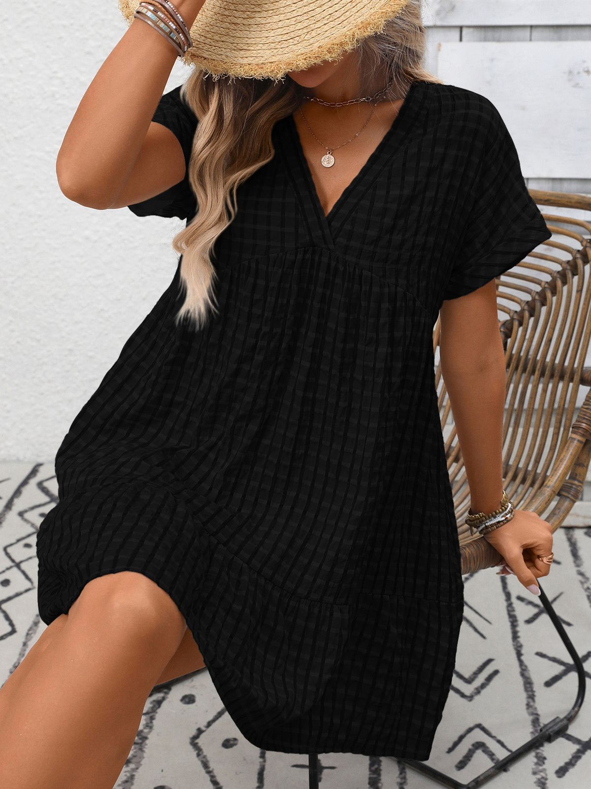 Chic plaid V-neck mini dress with ruffle hem from Plush Fashion Hub, featuring a stylish and feminine design perfect for casual wear.