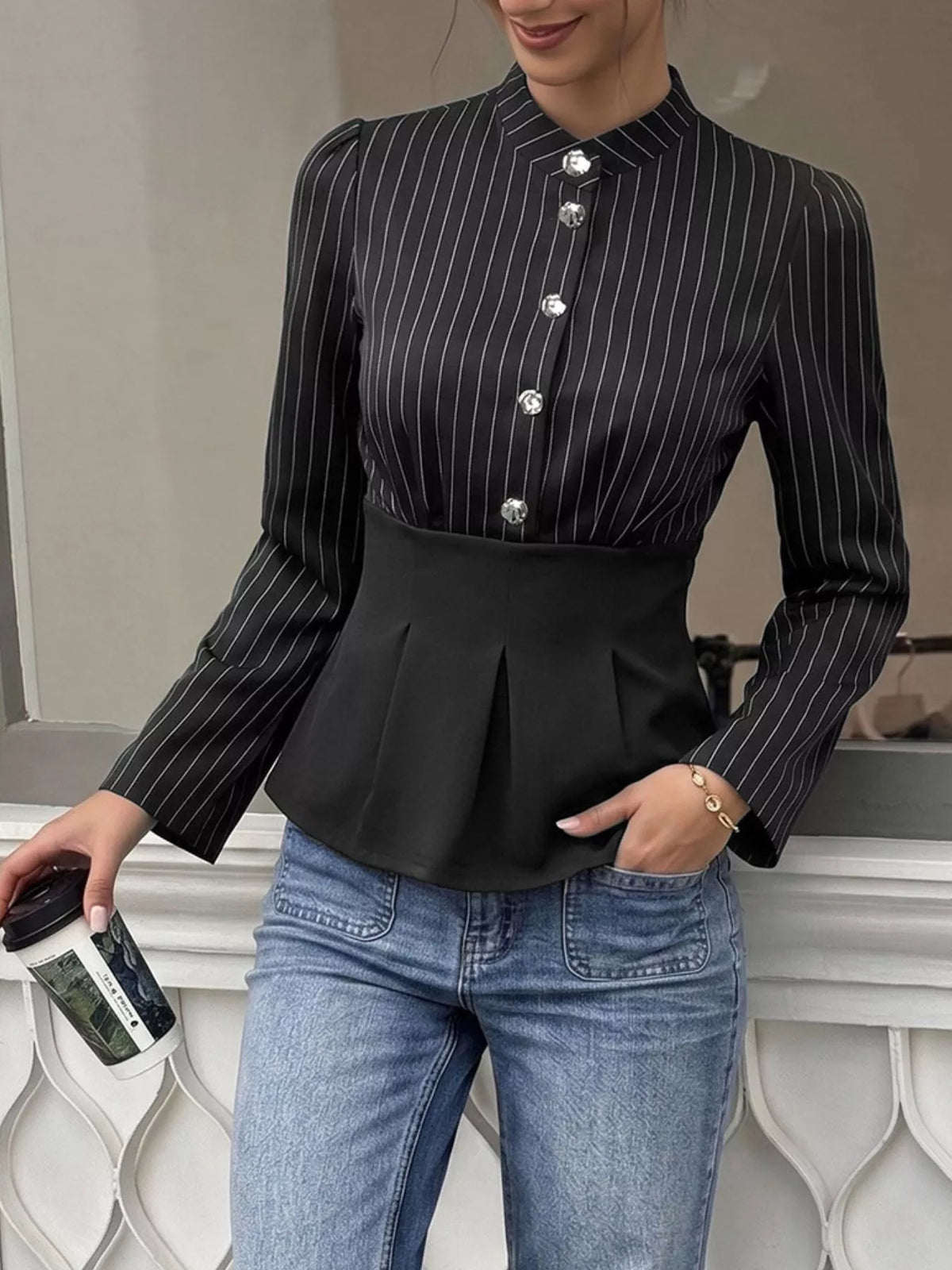Women's striped long sleeve peplum blouse by Trendsi featuring a fitted bodice, contrasting stripes, and a stylish peplum hem.