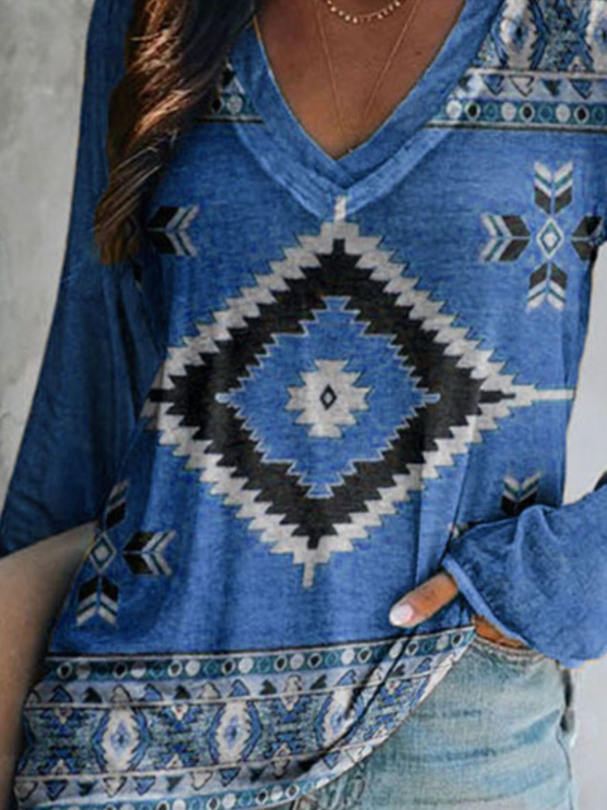 Plus size V-neck long sleeve T-shirt with geometric print in casual style from Plush Fashion Hub, shown in natural light.