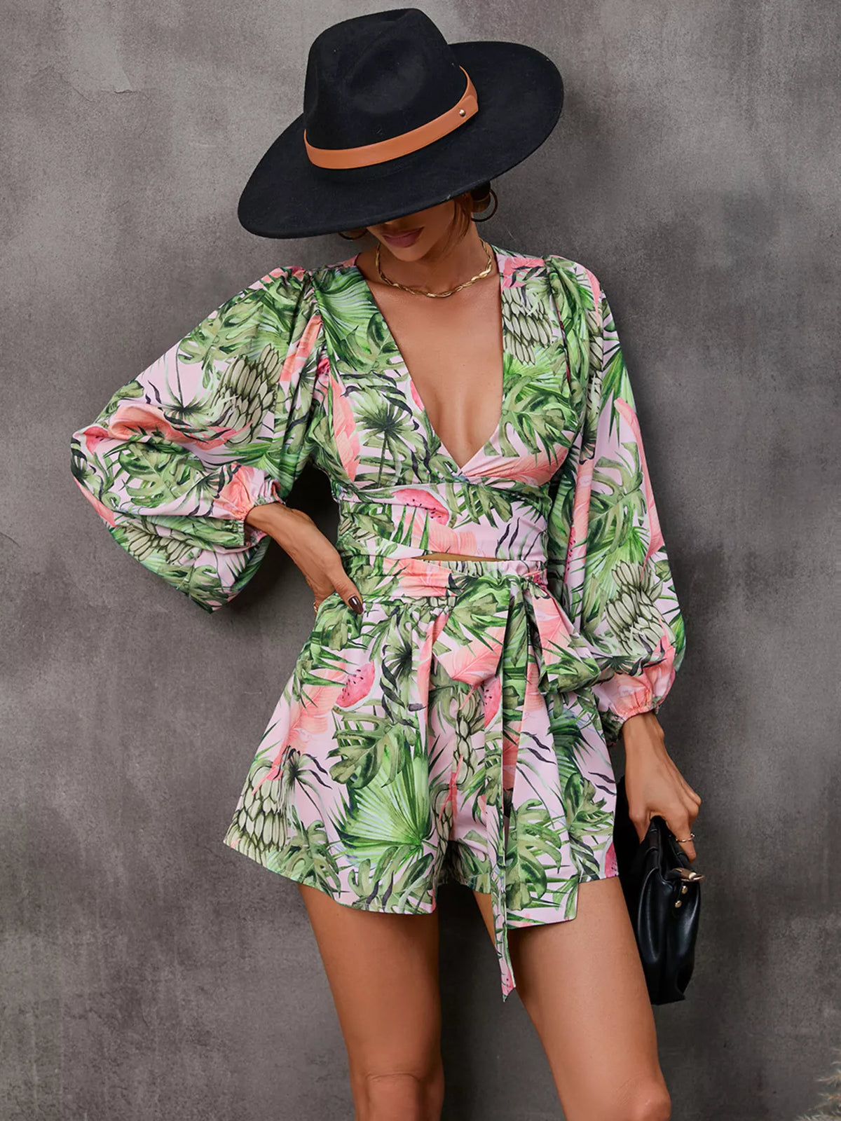 Printed long sleeve romper with front cutout, stylish jumpsuit by Plush Fashion Hub, shown with vibrant pattern and fitted design.