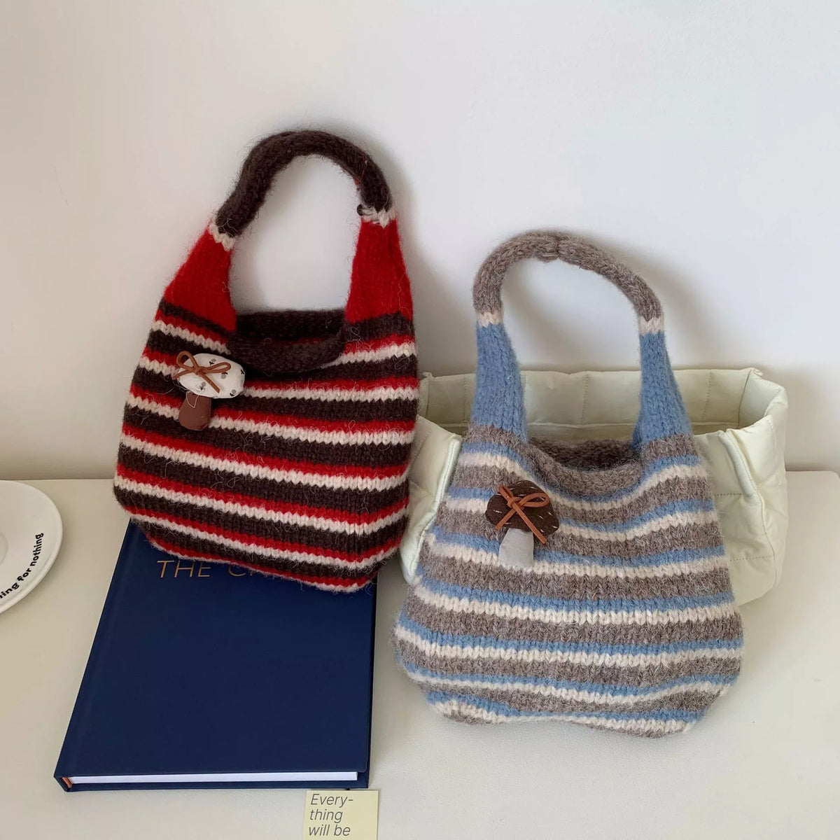 Knitted striped handbag by Plush Fashion Hub featuring colorful woven design and sturdy handles for casual style.