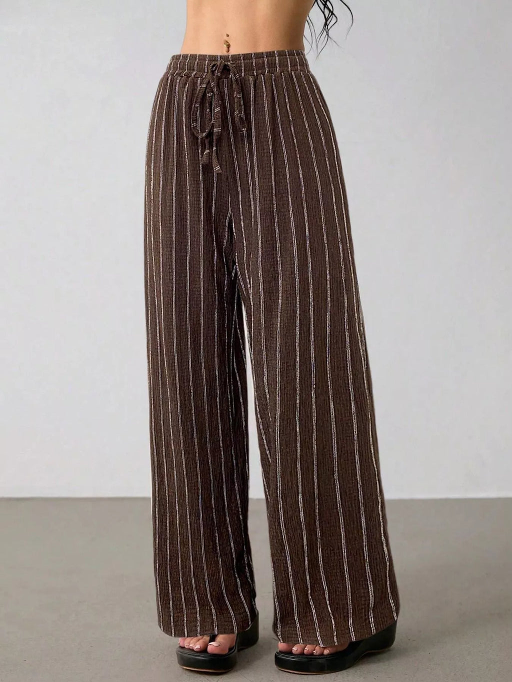 Striped wide-leg drawstring pants from Trendsi featuring a relaxed fit and comfortable waistband, showcased on a model.