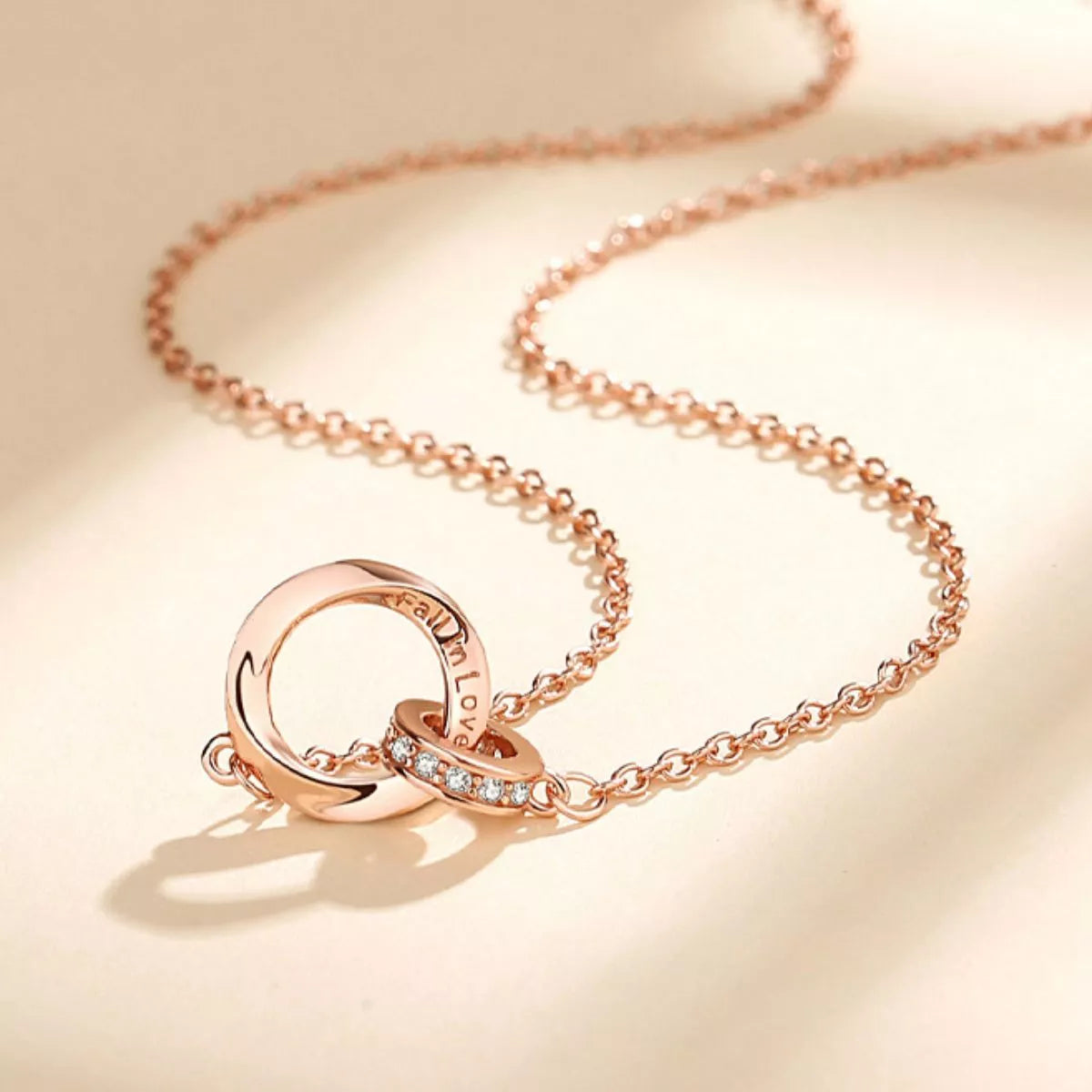 Sterling silver necklace with 18K rose gold plating, featuring a delicate chain and elegant pendant, crafted by Plush Fashion Hub.