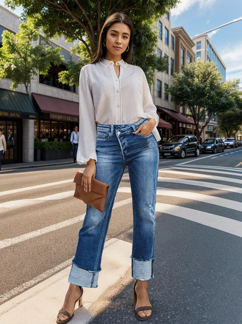 Pair of Trendsi denim jeans featuring a stepped waist, raw hem, and rolled straight fit displayed on a hanger.