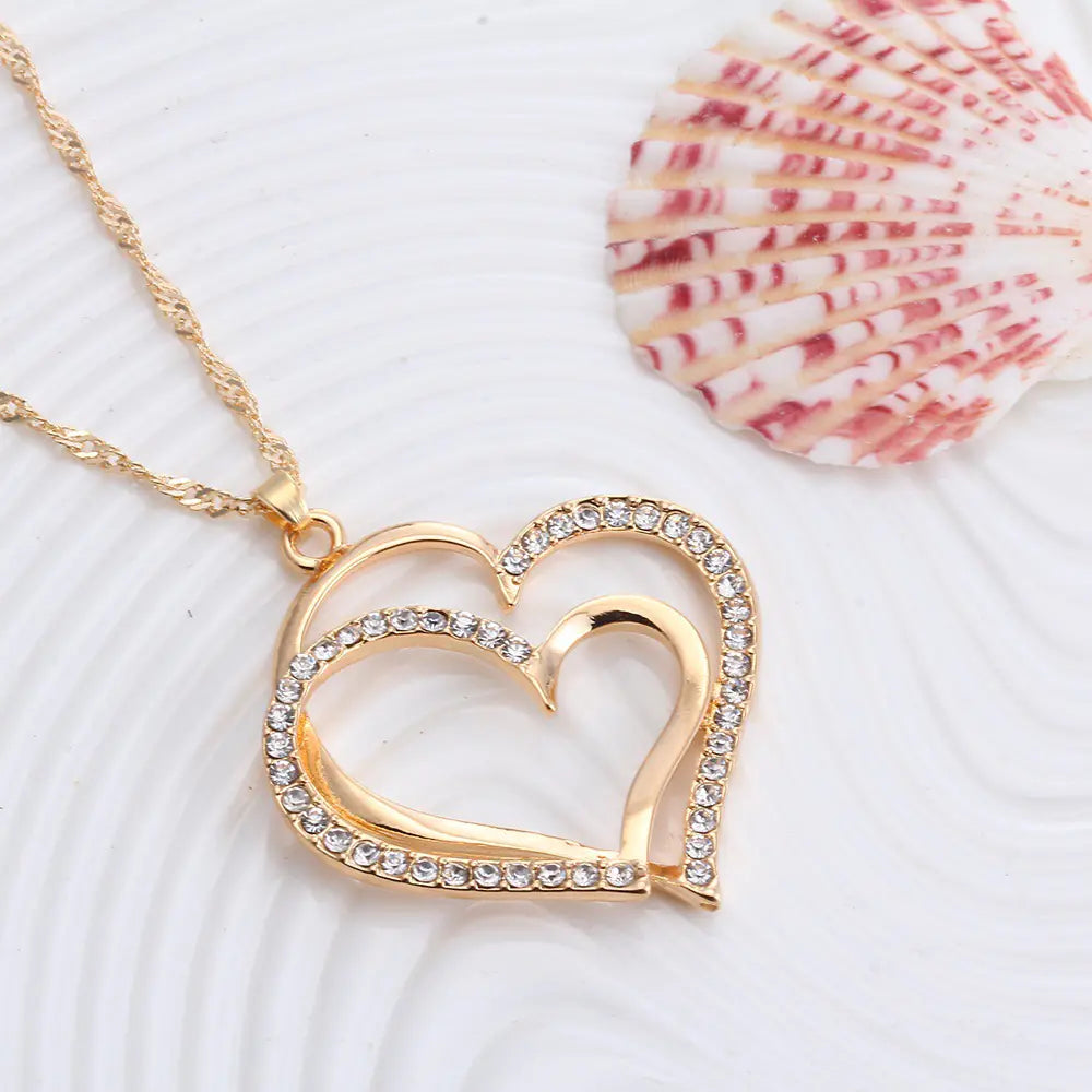 Double heart wedding jewelry set featuring a necklace and matching earrings with elegant design, ideal for special occasions.