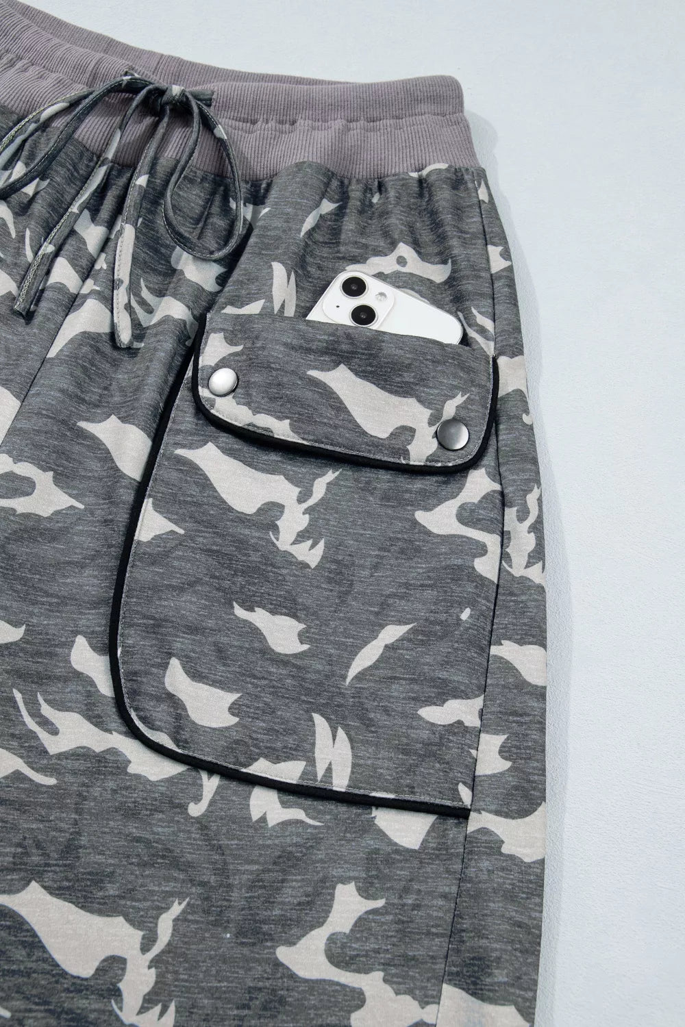 Multicolour camouflage cargo barrel pants with contrast waistband and drawstring from Plush Fashion Hub, shown with relaxed fit and multiple pockets.