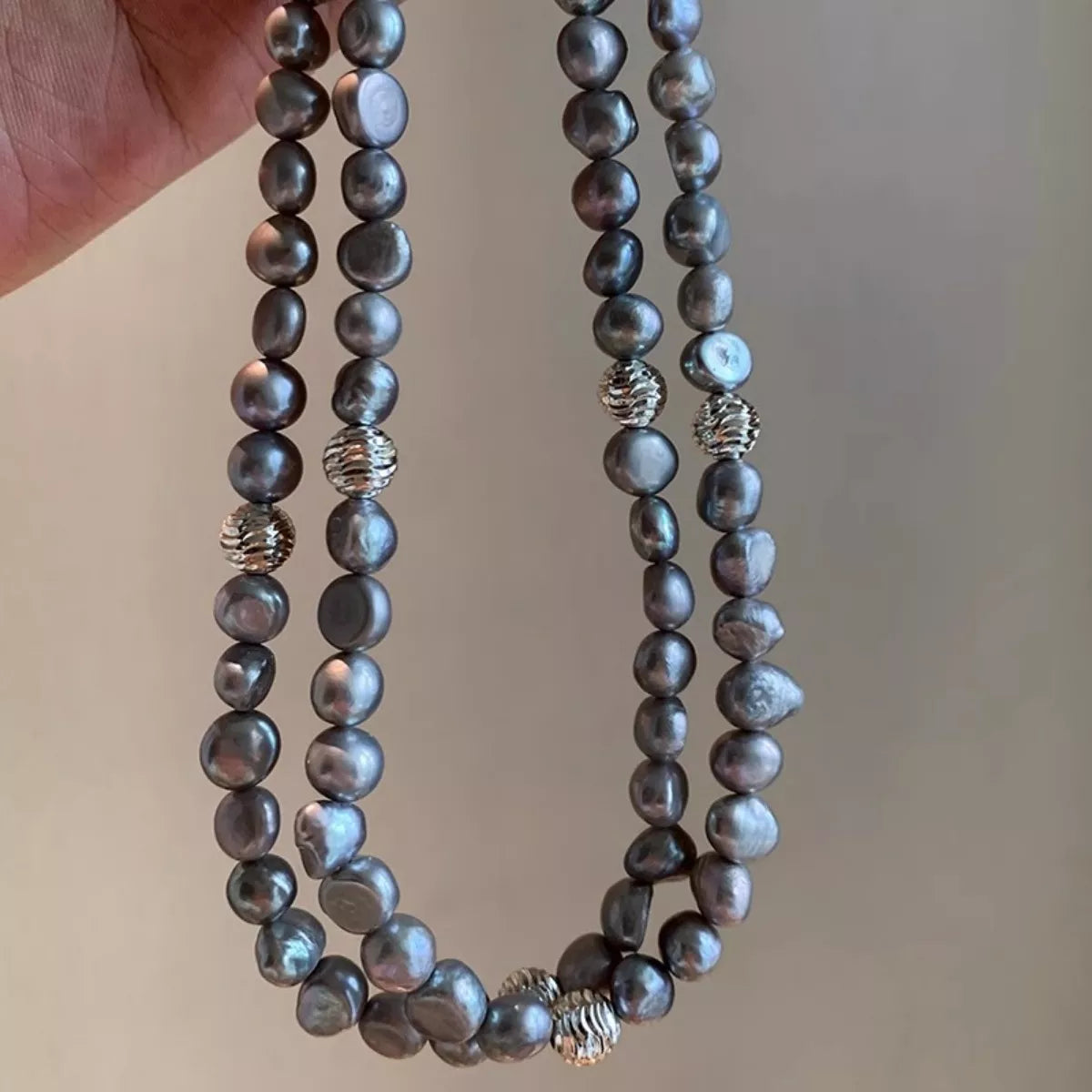 Elegant pearl choker necklace from Plush Fashion Hub featuring a string of white pearls on a delicate black ribbon.