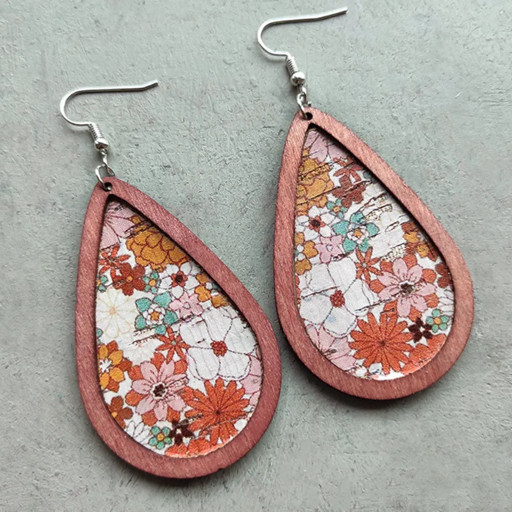 Floral wood teardrop earrings by Plush Fashion Hub featuring colorful flower details and natural wooden teardrop shape.