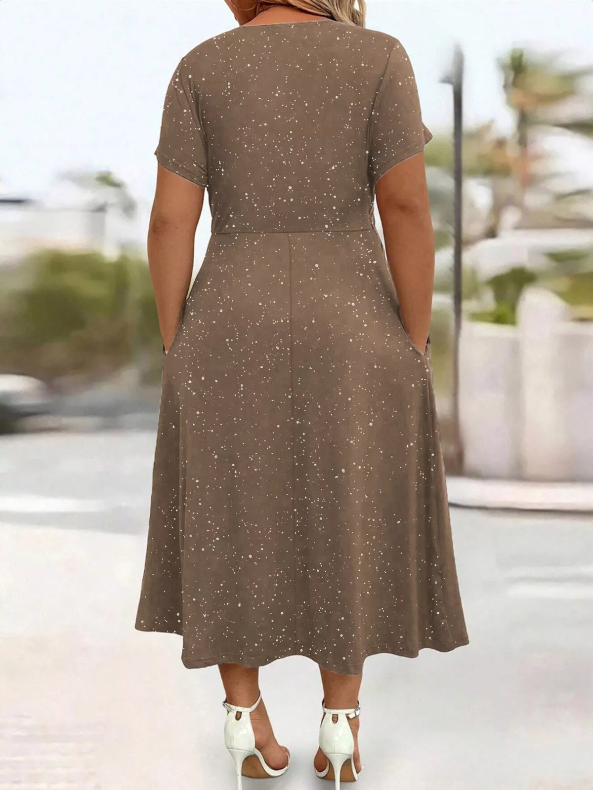 Plus size glitter flutter sleeve midi dress by Trendsi, showcasing a shimmering fabric and stylish flutter sleeves.
